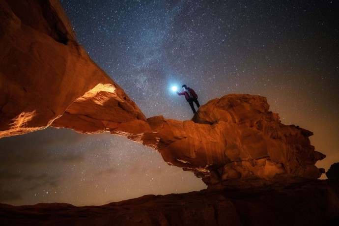 Night and star scene of stone arc in Wadi Rum, Jordan