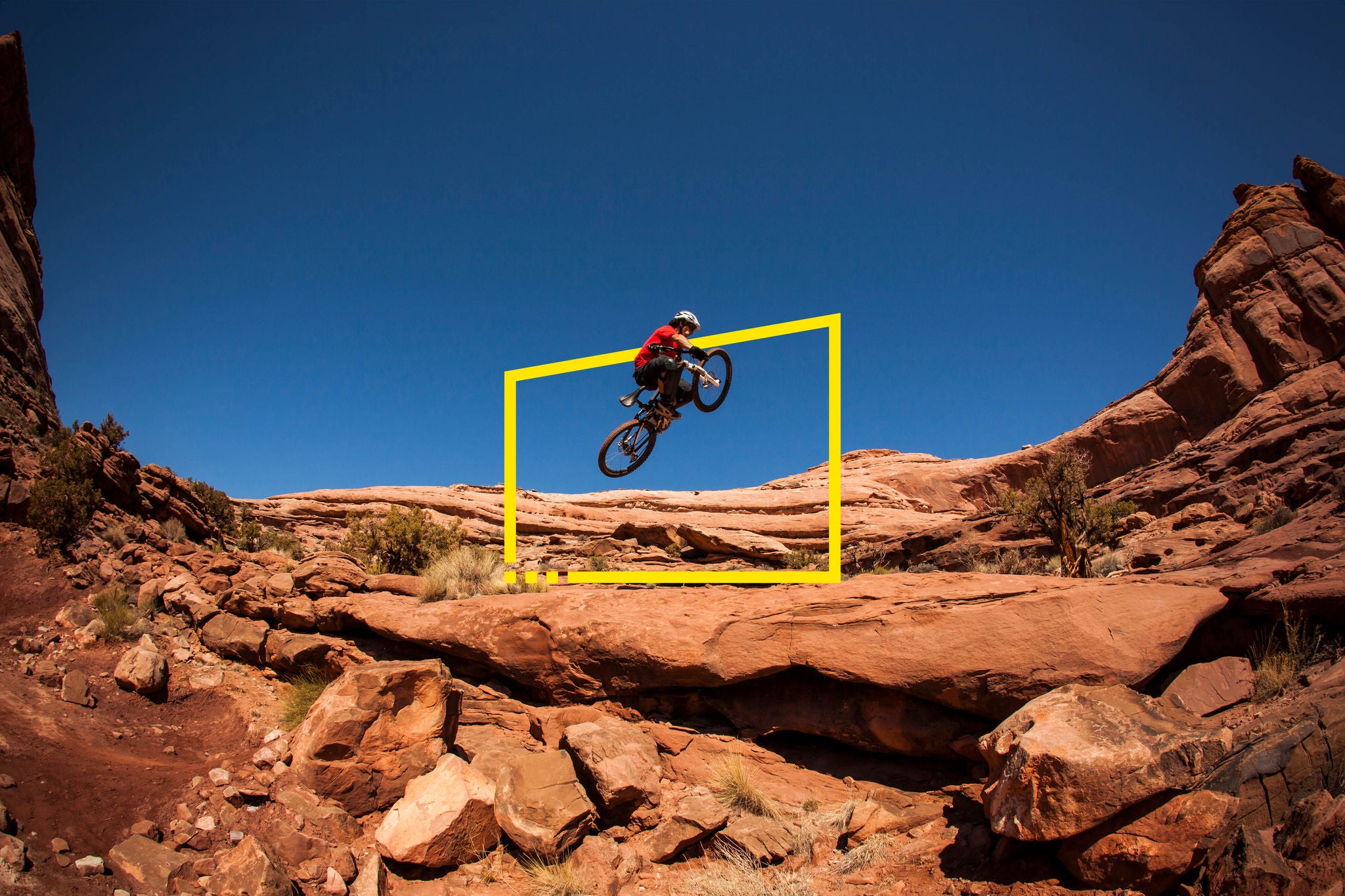Man getting air on a jump on his mountain bike near Moab Utah static no zoom
