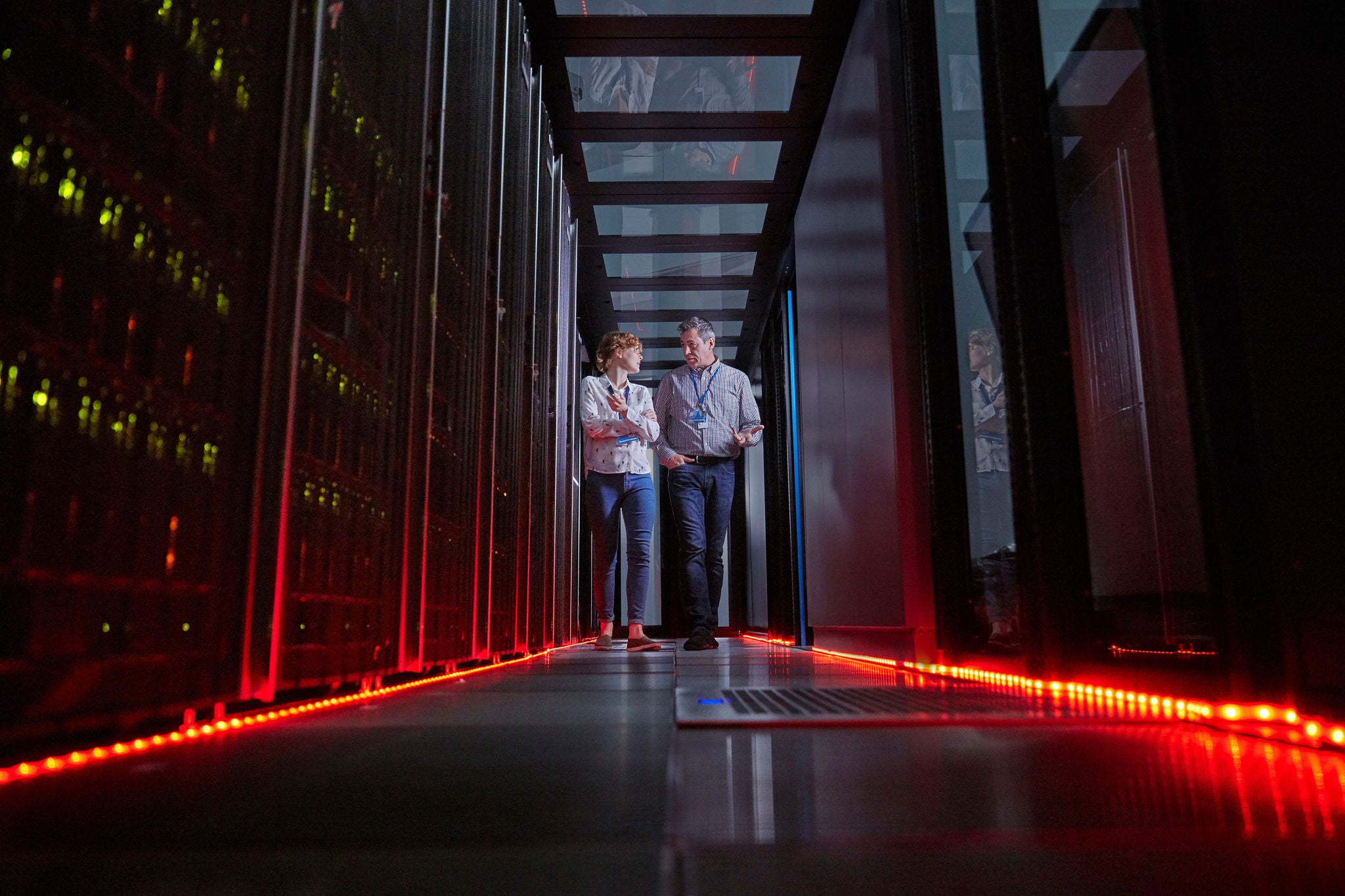 Men and women are walking in the server room