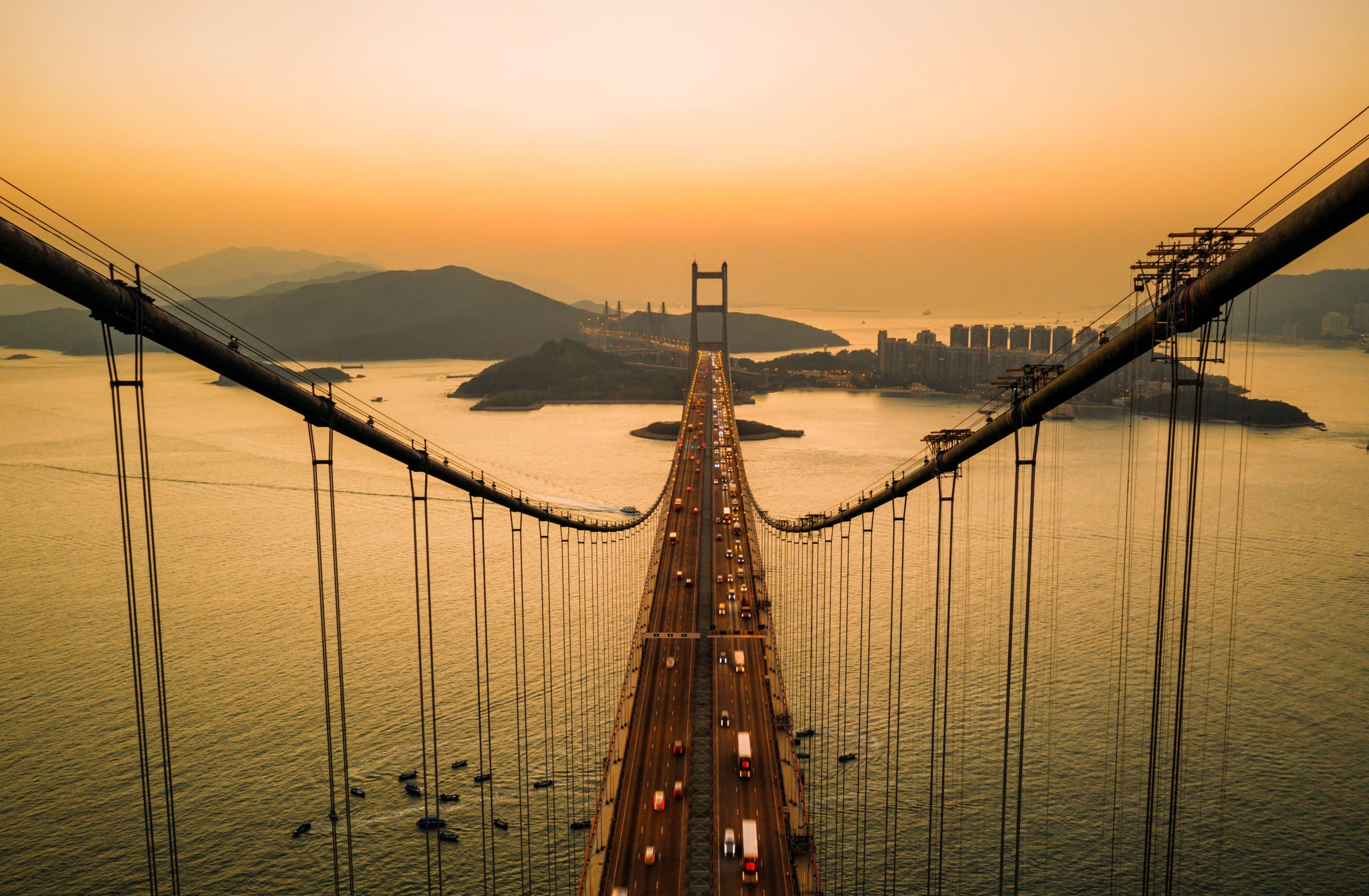 Aerial view of traffic of cars at Tsing Ma bridge in Tsing Yi area of Hong Kong at sunset