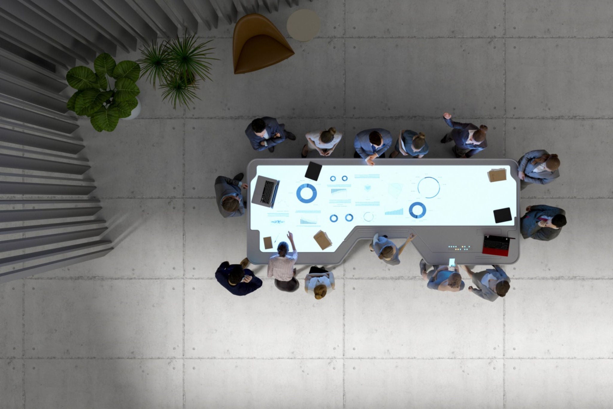 Ariel view of a employees in formals attending conference meeting around a table with presentation screen