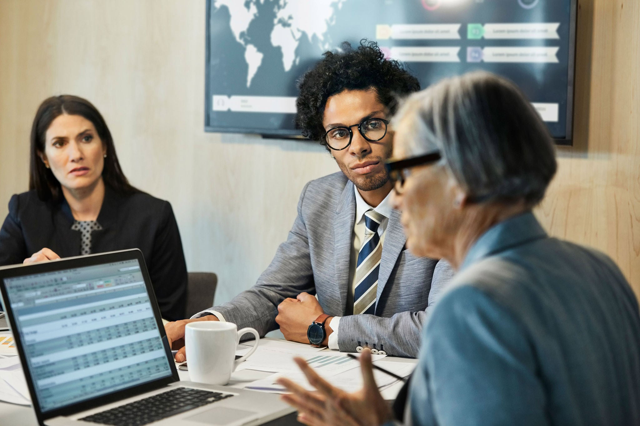 Businesswoman with coworkers in board room