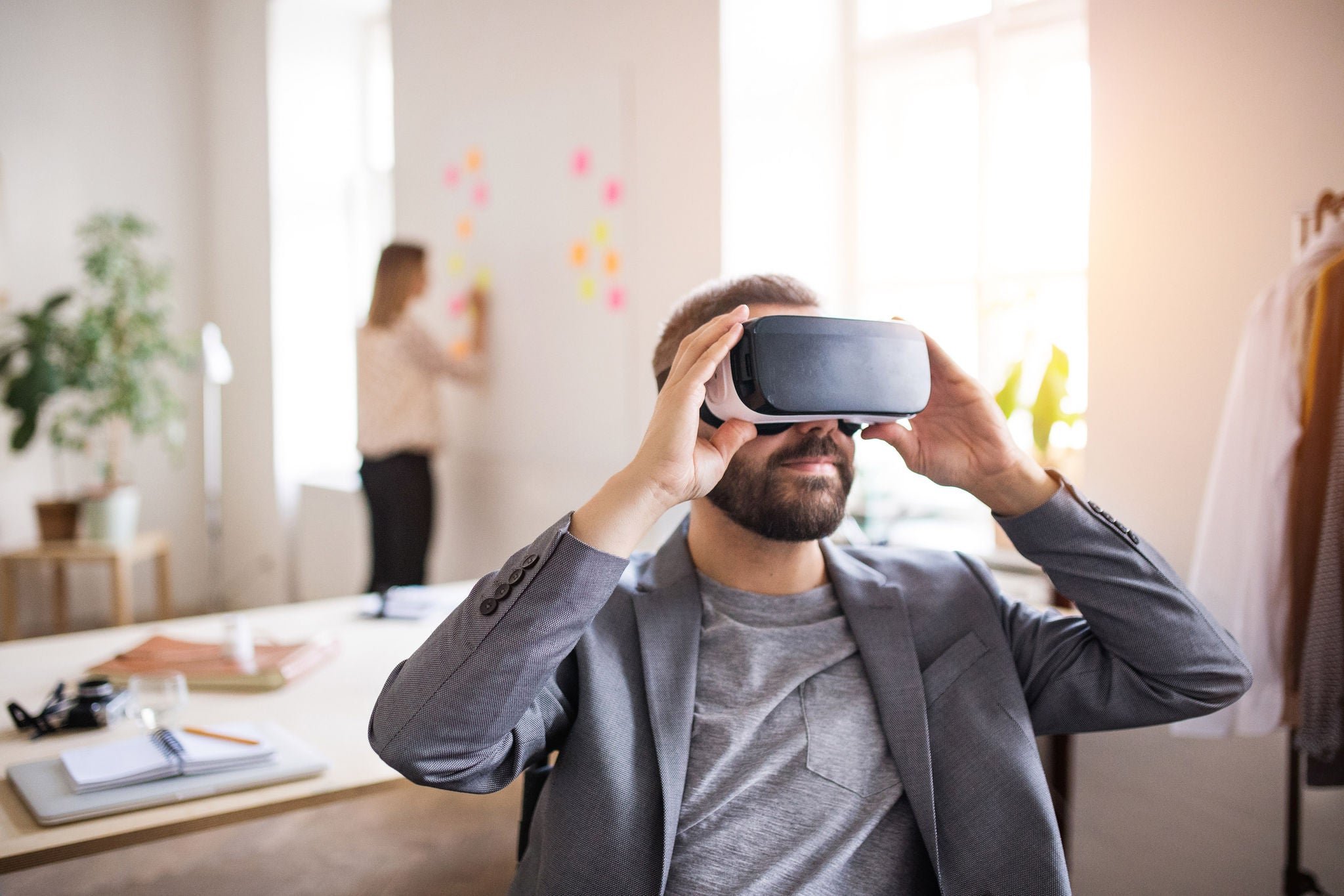 Ey two business people with wheelchair and vr goggles in the office