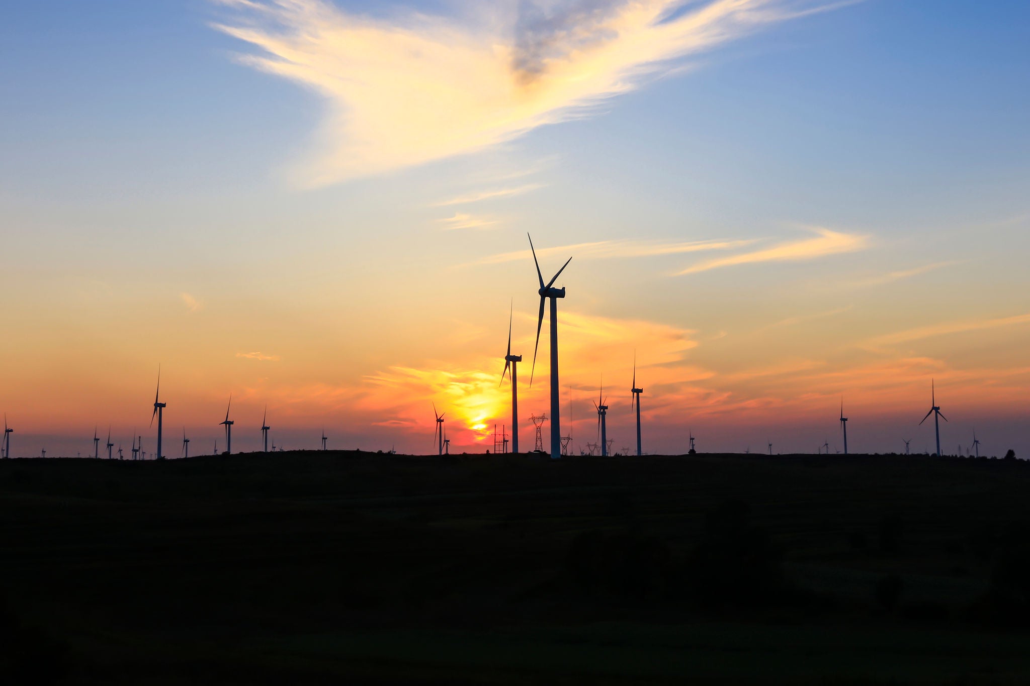 In the evening, the silhouette of wind turbines