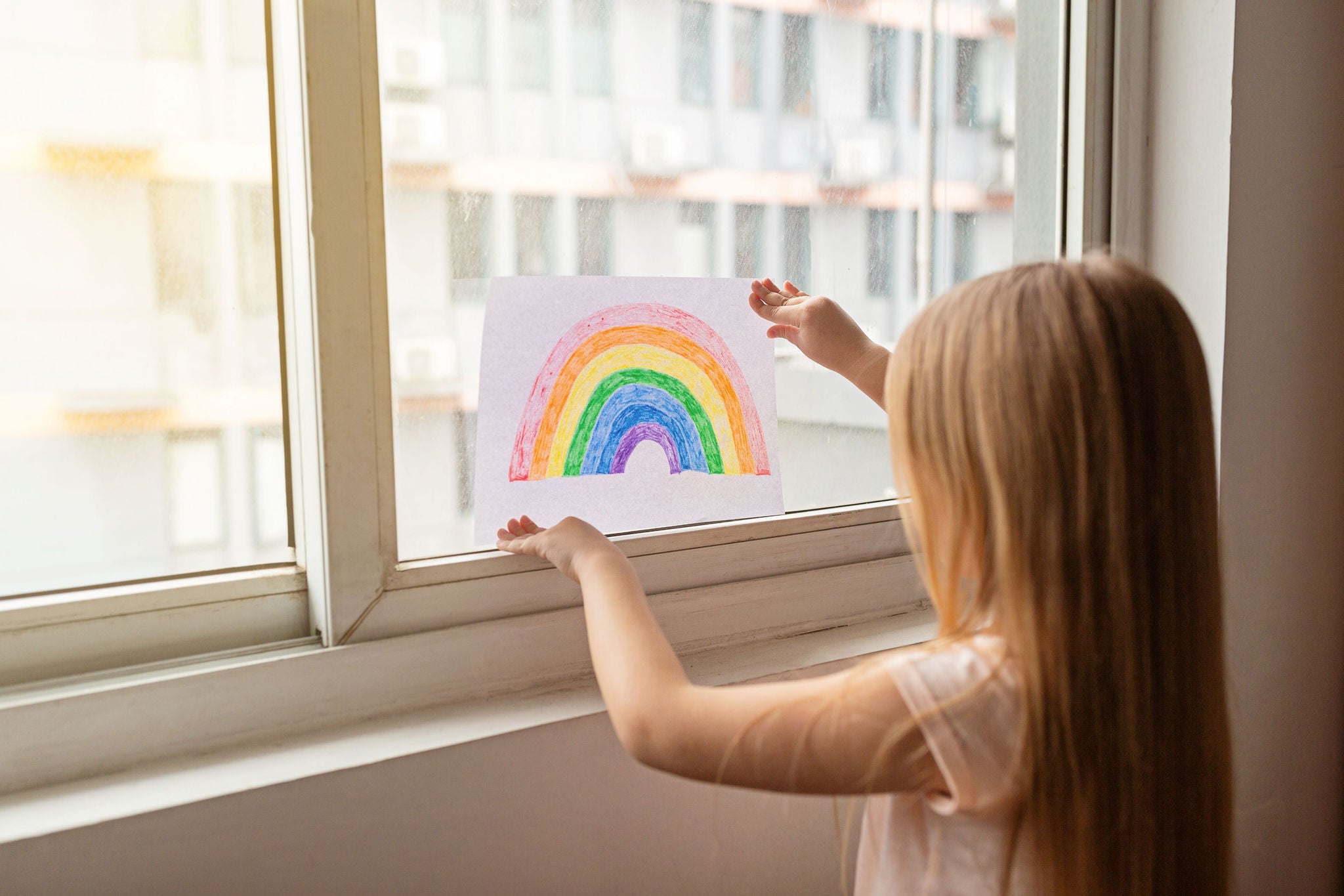 Kid painting rainbow during covid 19 quarantine