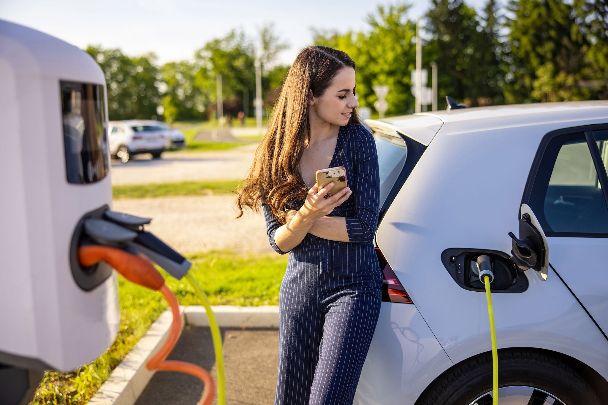 Women charging electric car