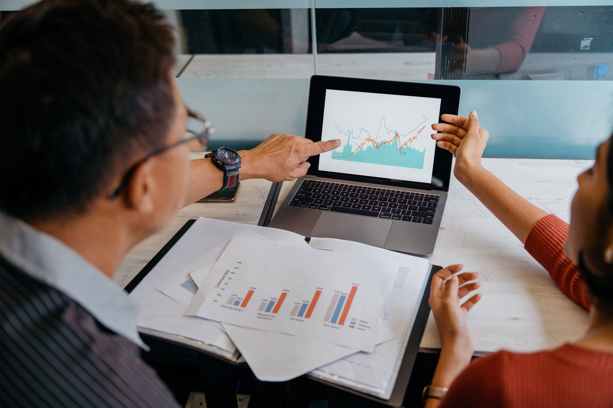 Image of a team of asian business people doing market research and business plans in office