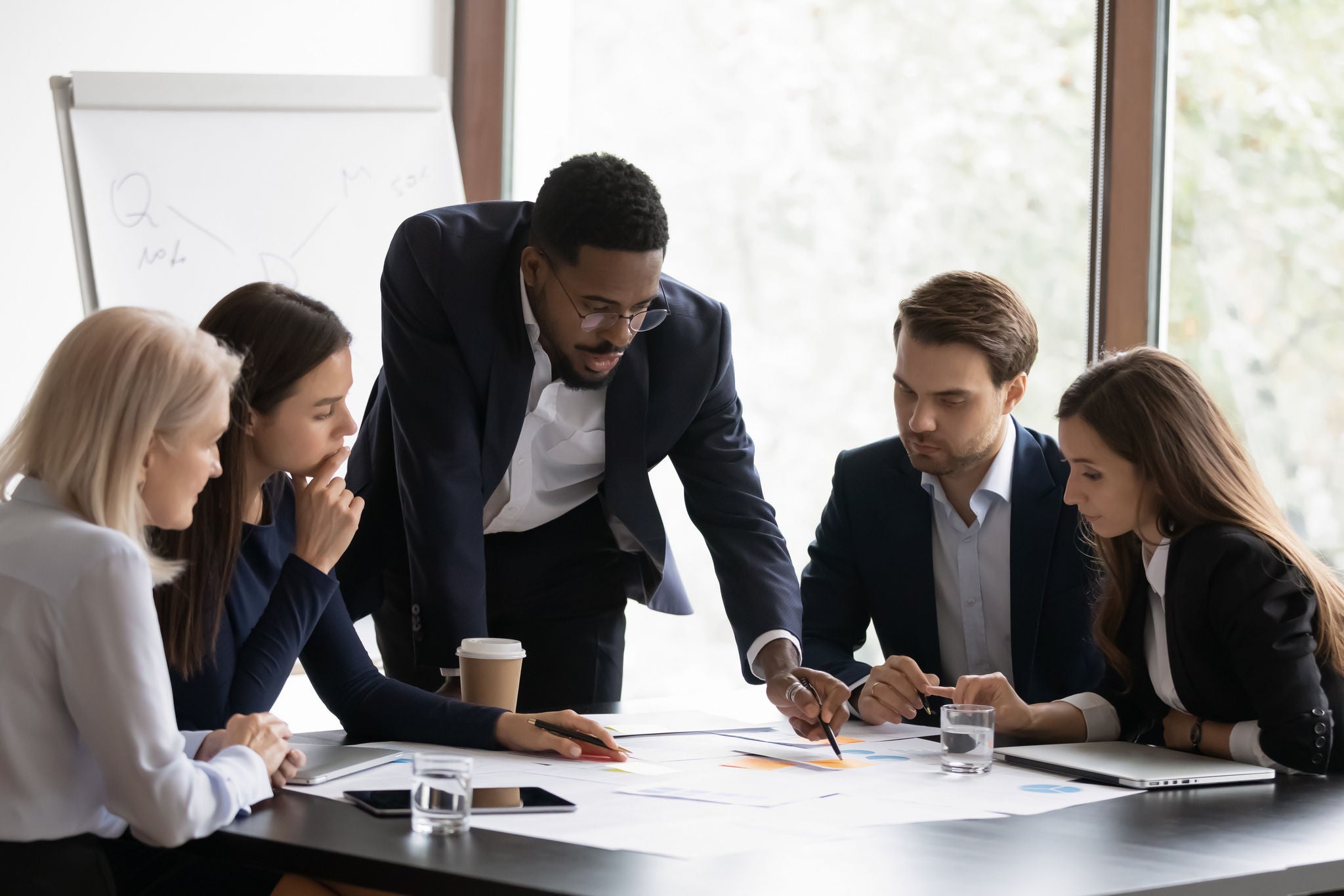 Confident biracial businessman head meeting with diverse colleagues