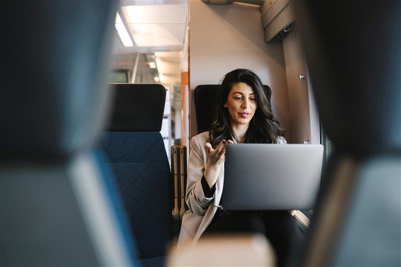 Woman using laptop in a train