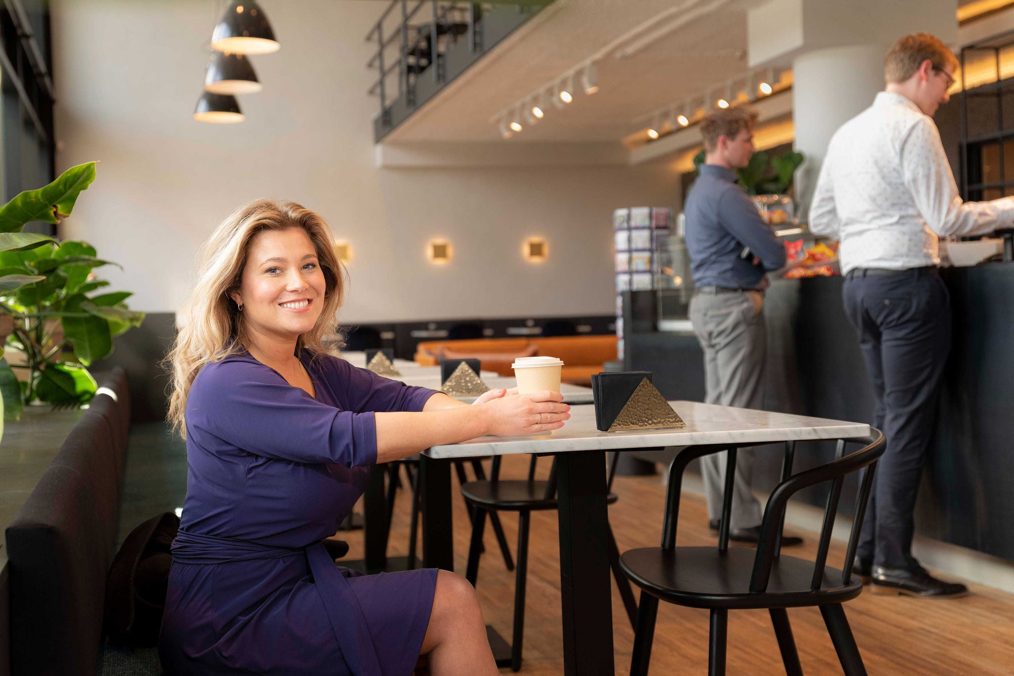 A lady is sitting in cafe shop