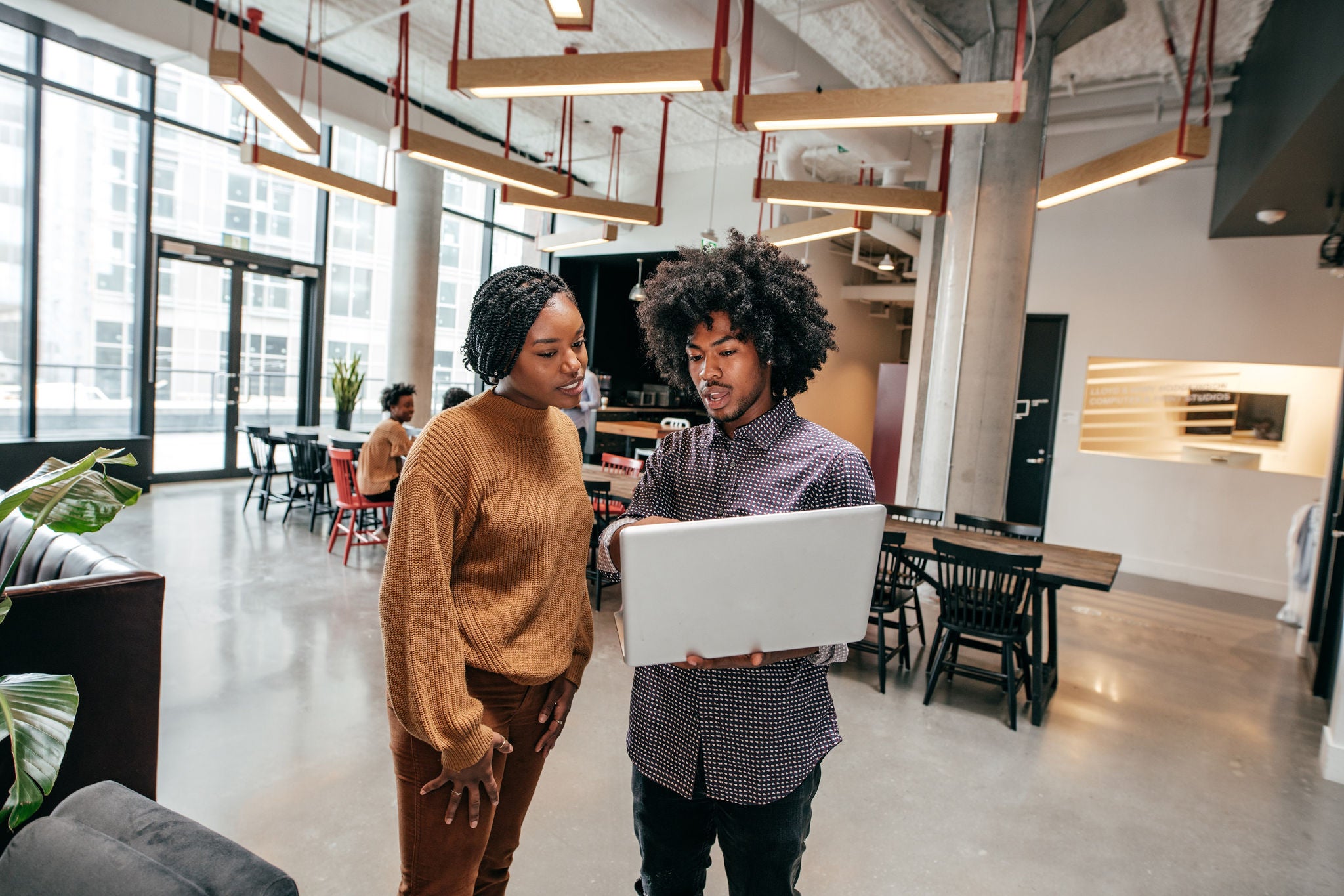 Man and woman working together in laptop