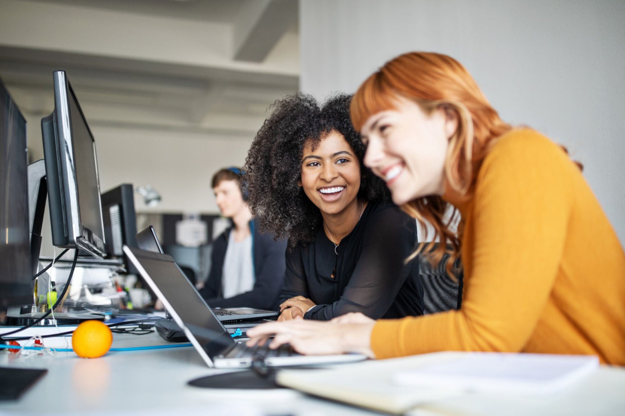 women smiling while working