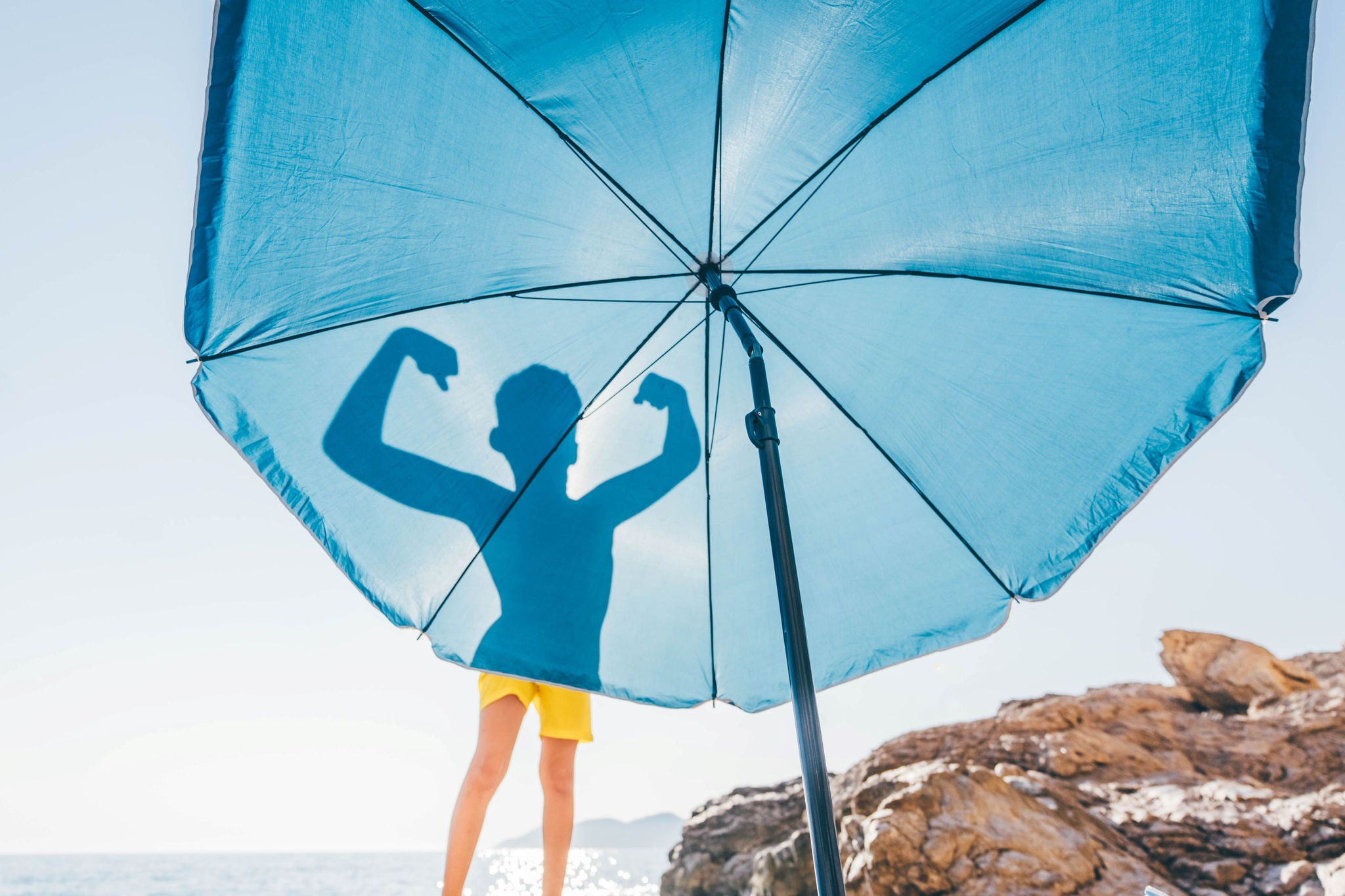 Garçon devant un parasol