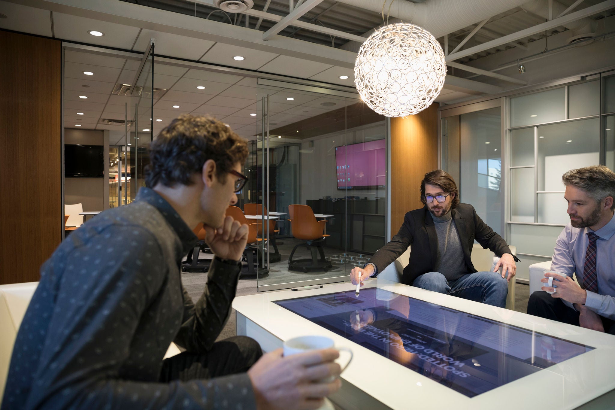 Businessmen meeting using interactive touch table in office