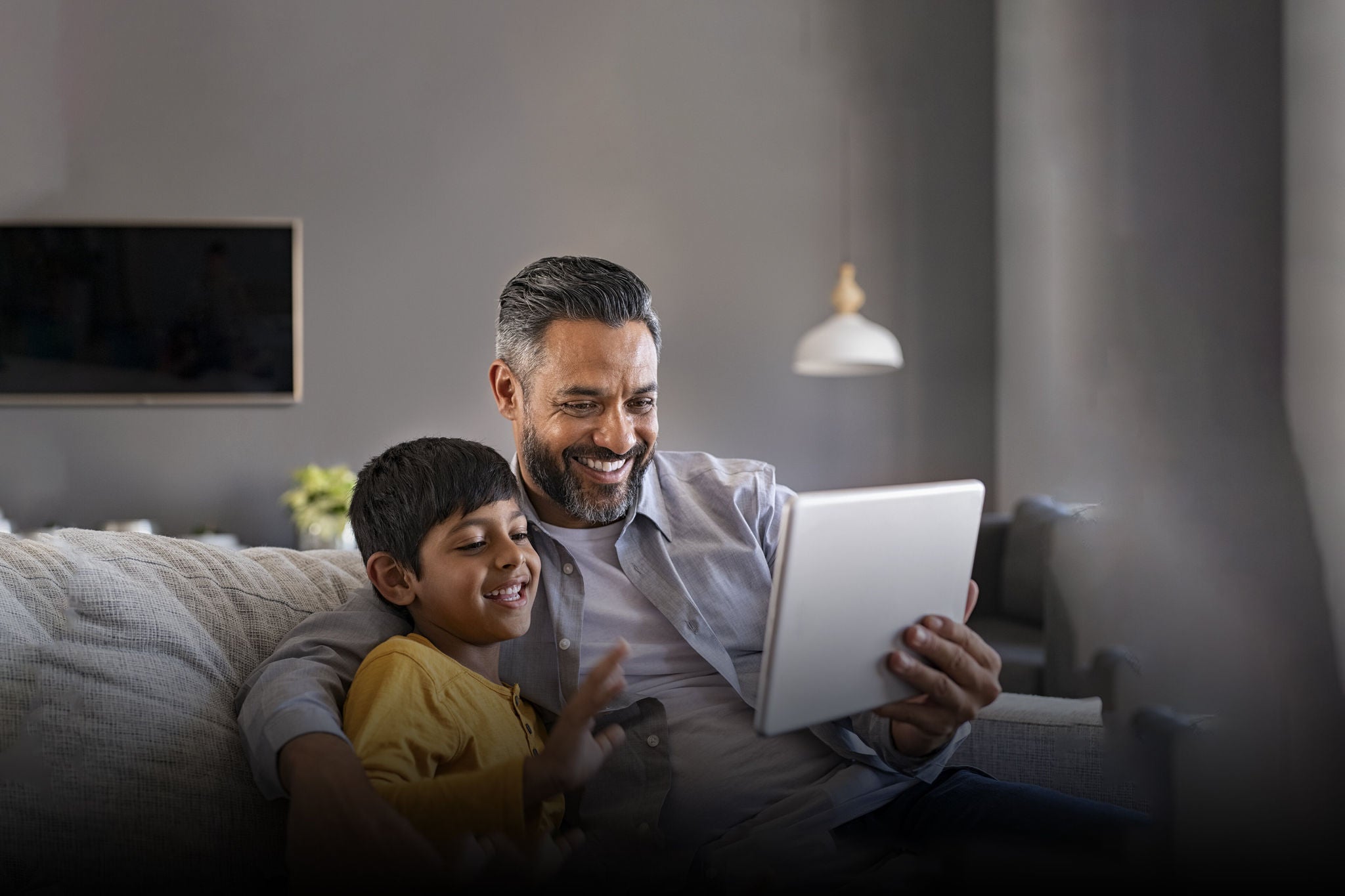 EY father and son playing in laptop