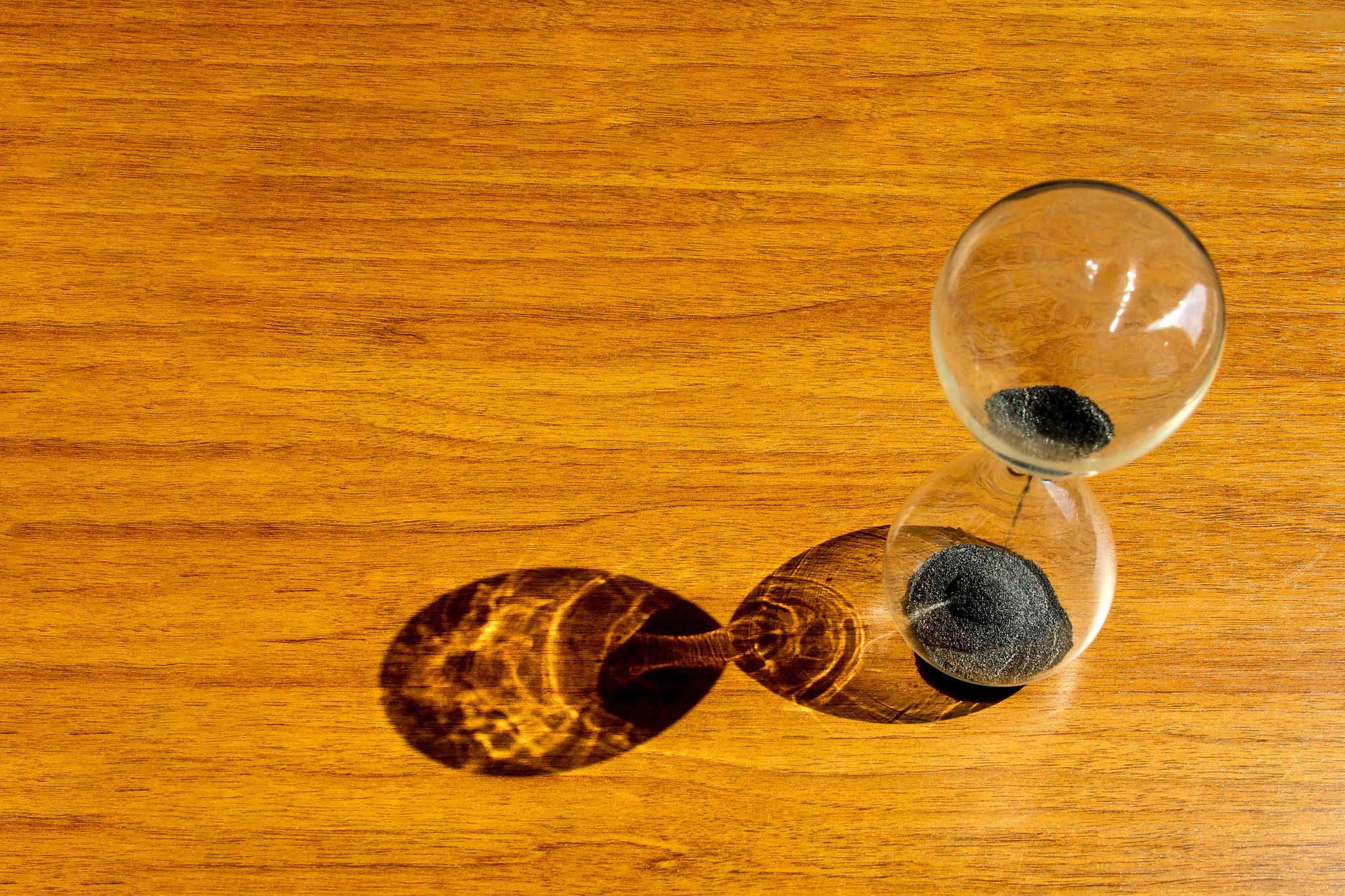 High angle view of hourglass on wooden table