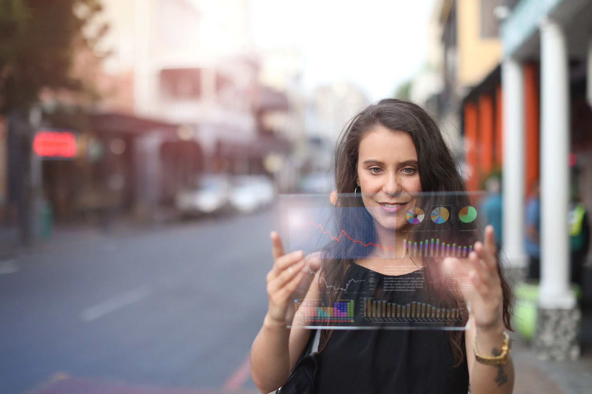 a Young woman looking at financial figures on a tablet..