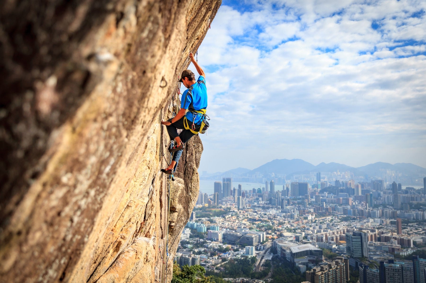 Man climbing hongkong blue sky