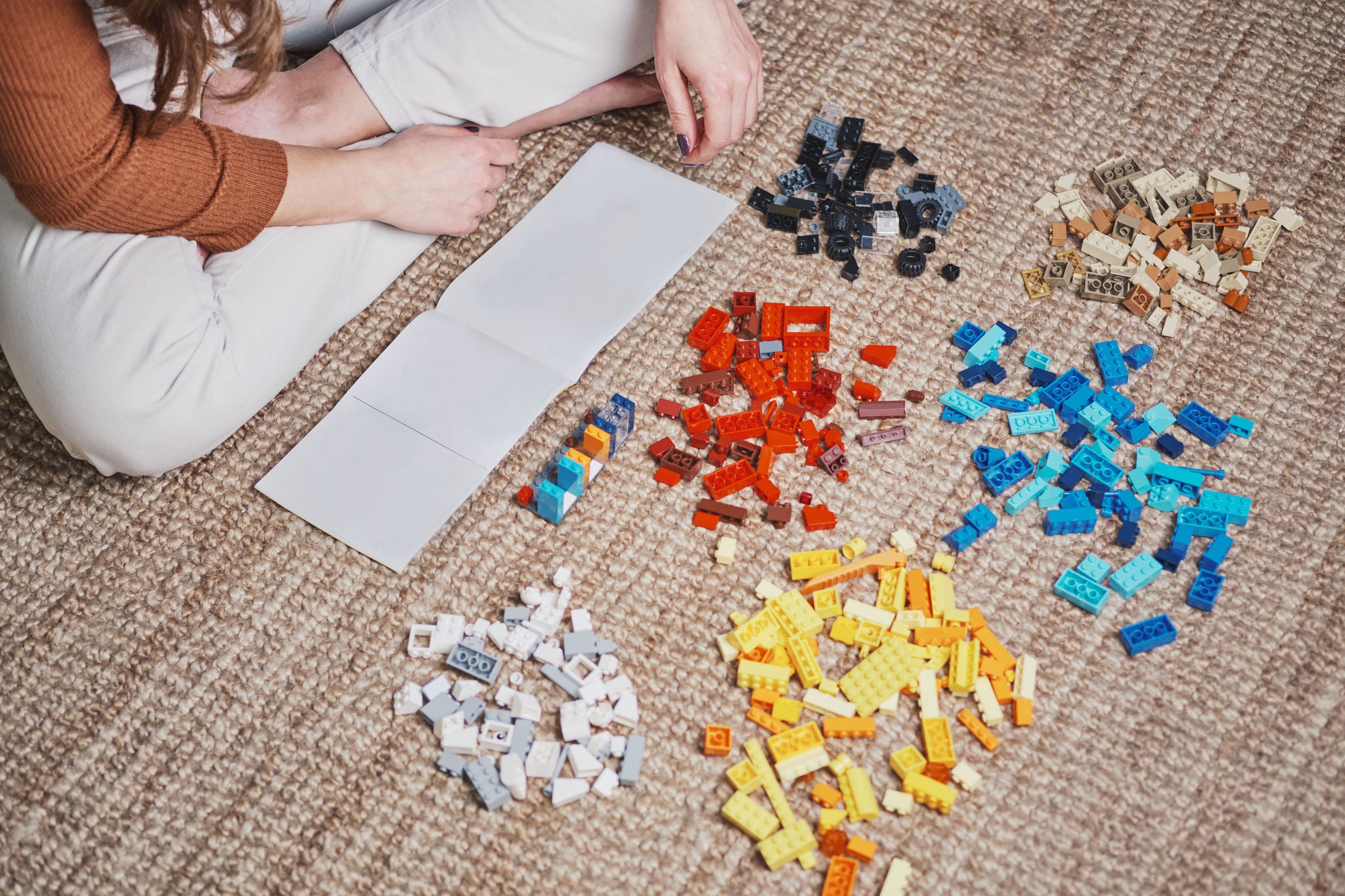 Picture of female hands playing with toys on the carpet