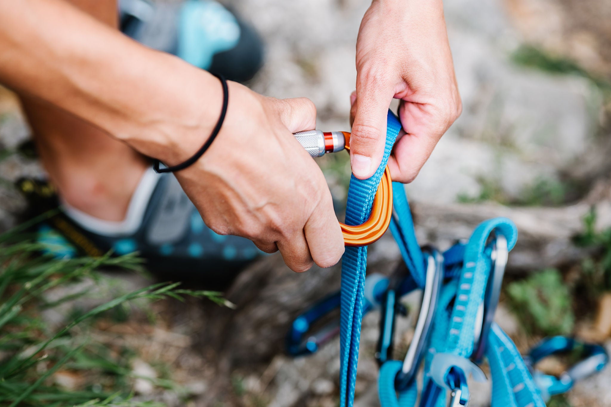 Hands Of Woman Attaching Belt On Carabiner