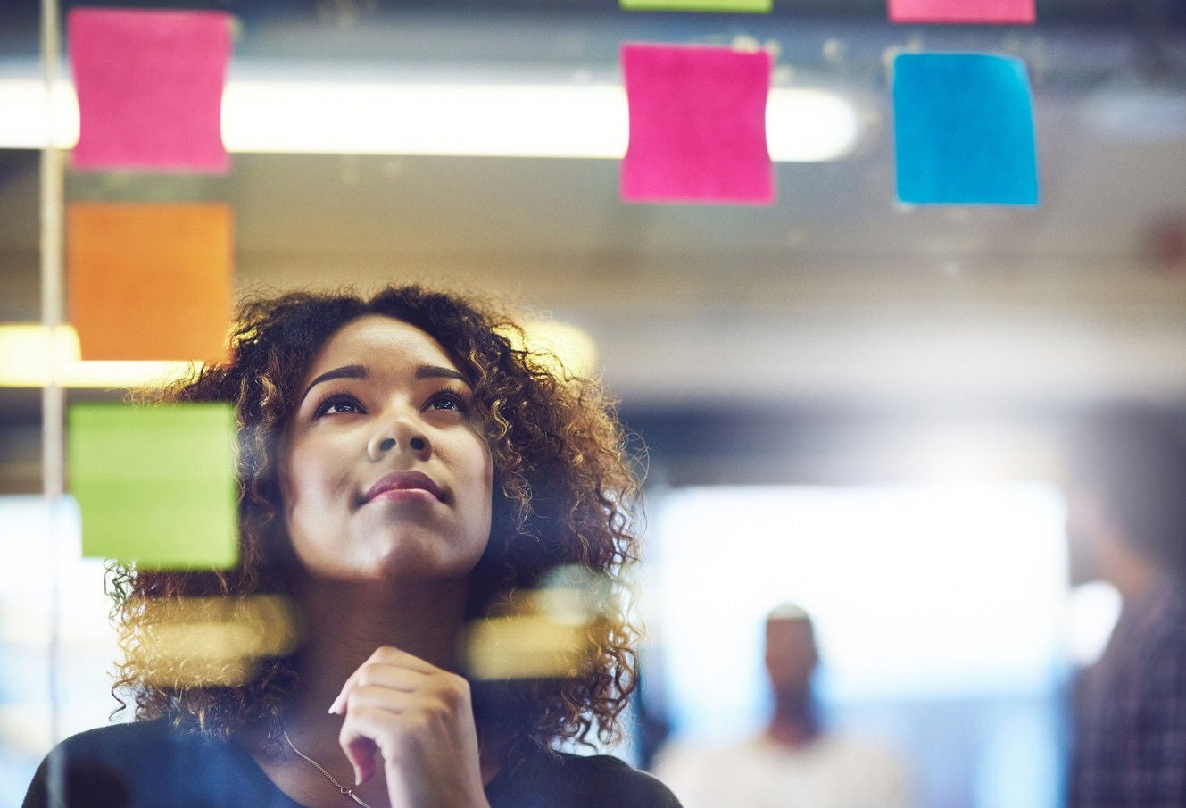 Young lady checking the sticky notes