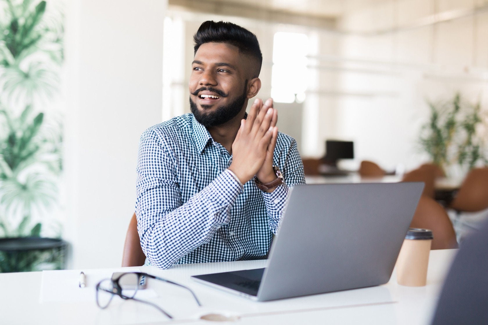 A man looking outside by keeping laptop infront