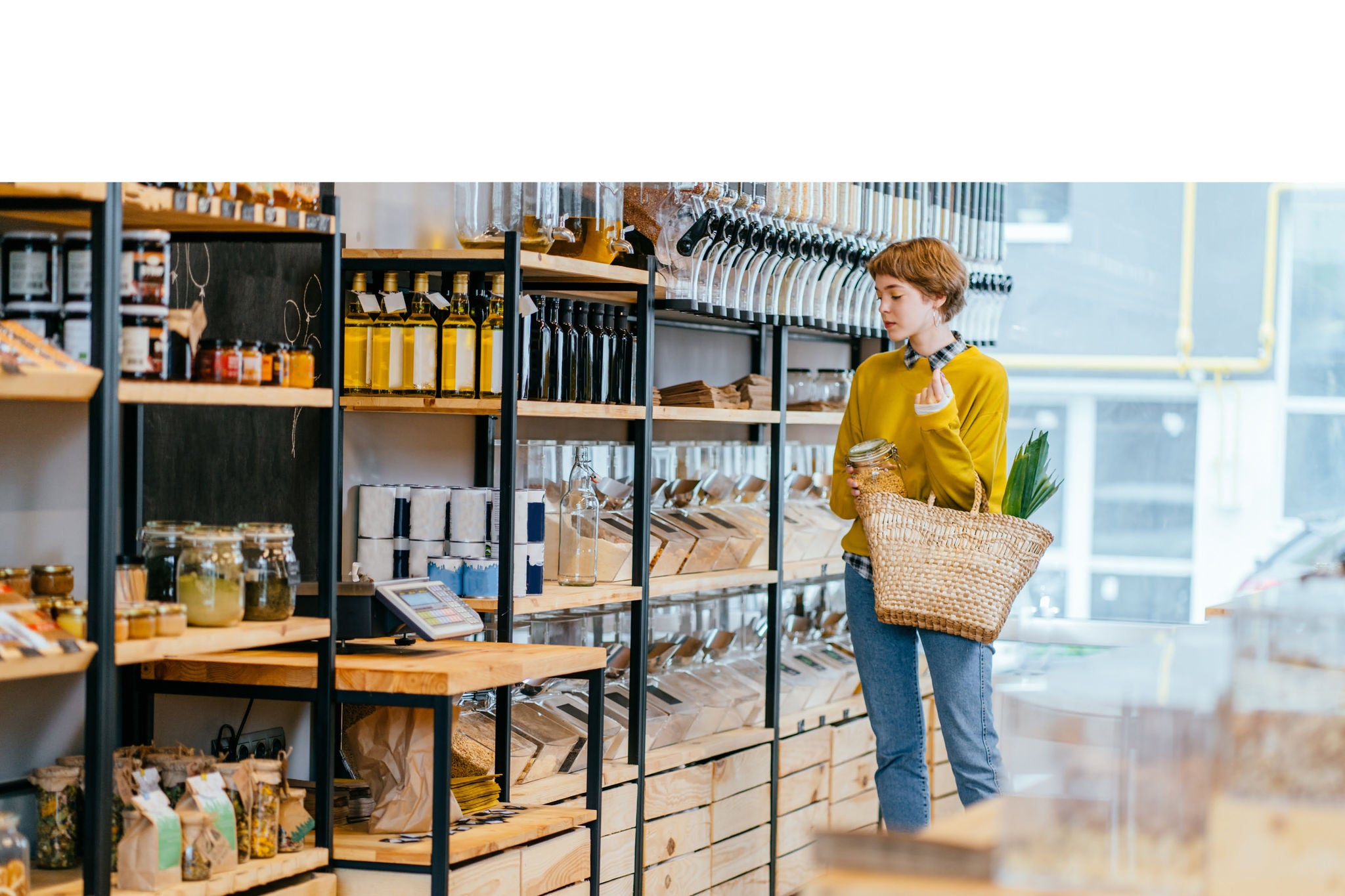 Young Mixed Race Woman Buying Superfoods in Zero Waste Shop.