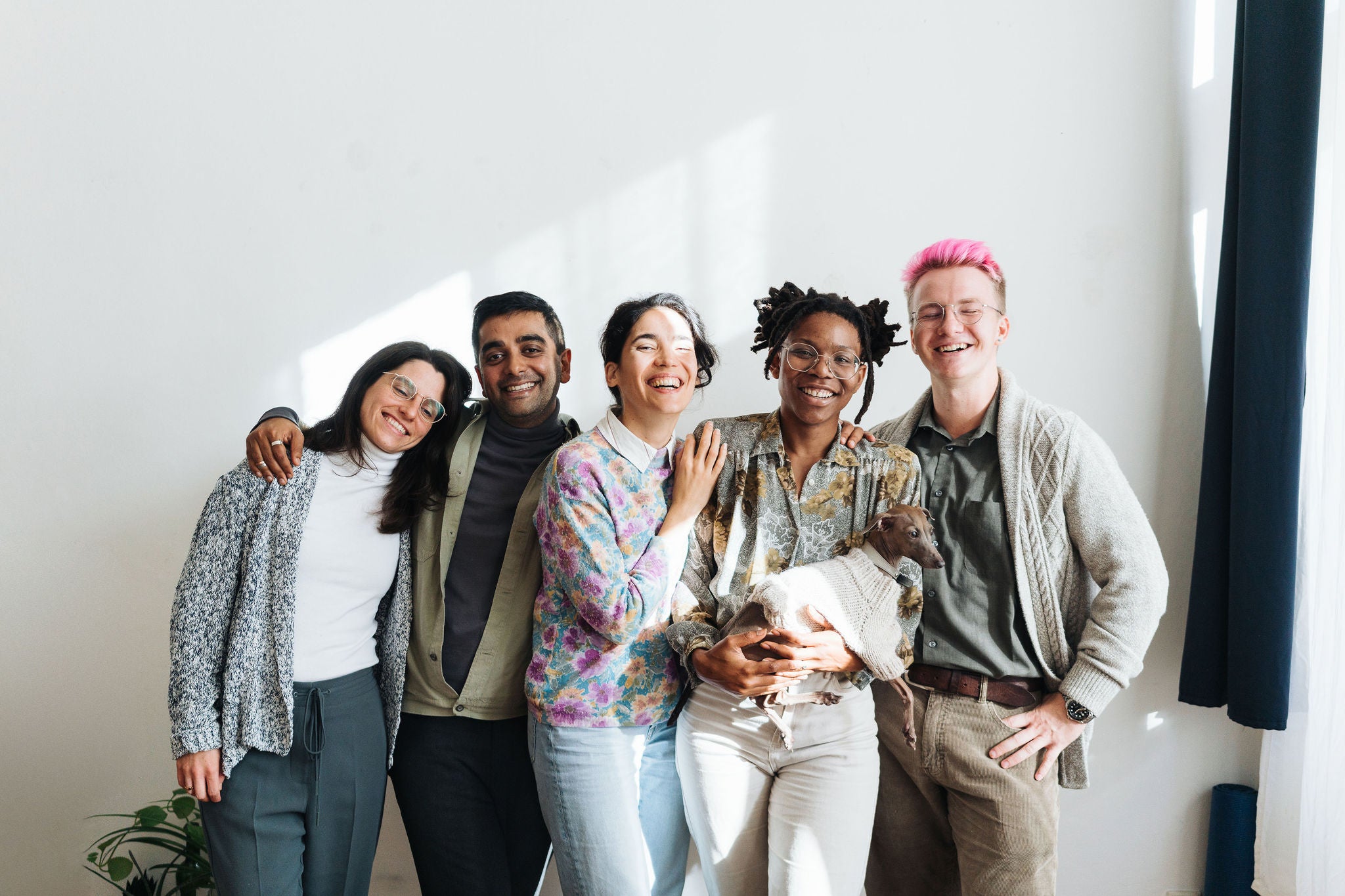 Group portrait of people standing in front of white background