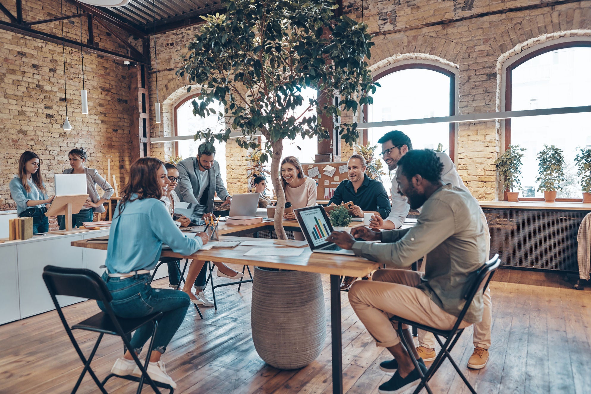 Group of young modern people in smart casual wear communicating