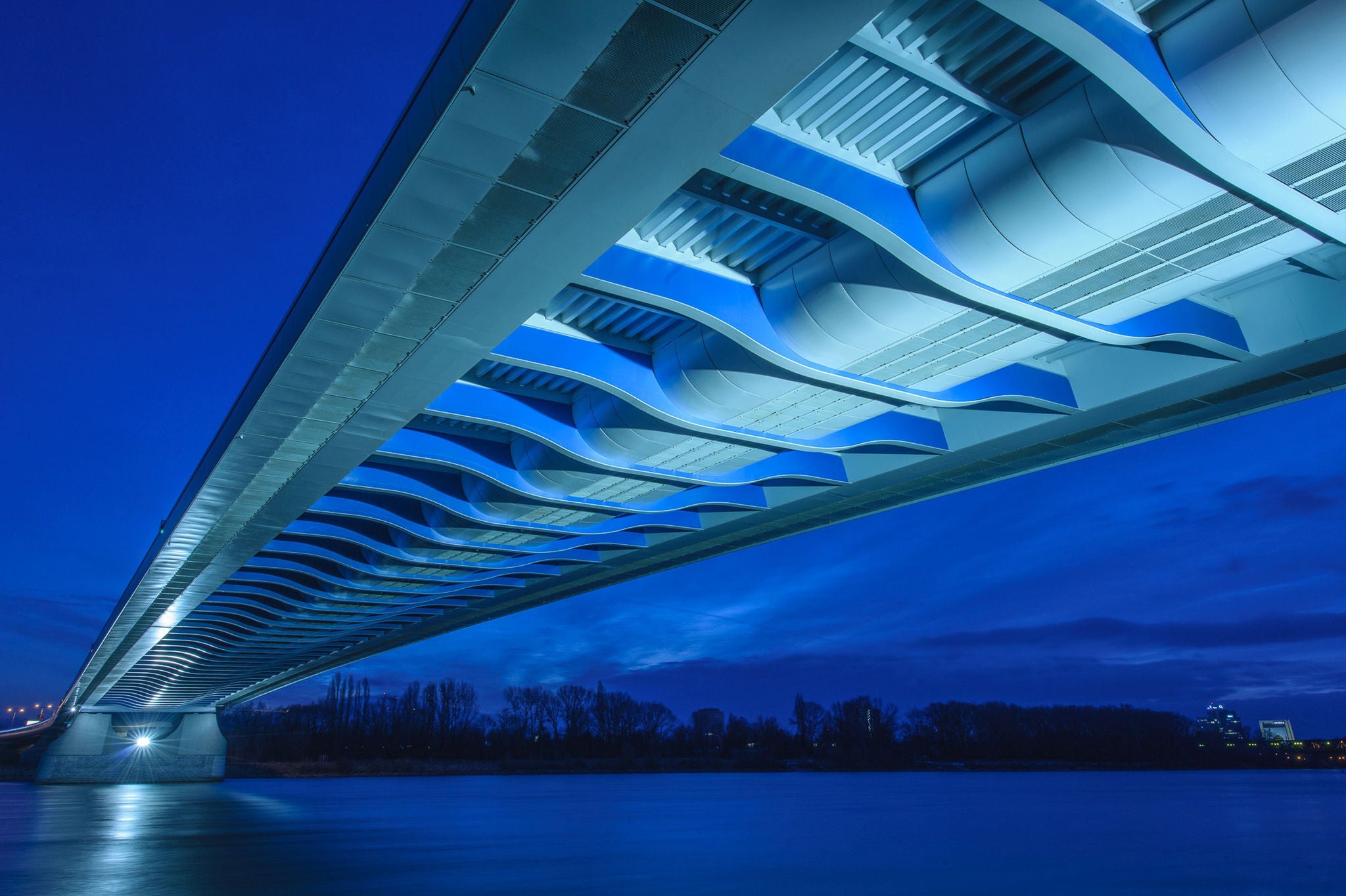 Low Angle View Of Illuminated Bridge Against Blue Sky At Dusk