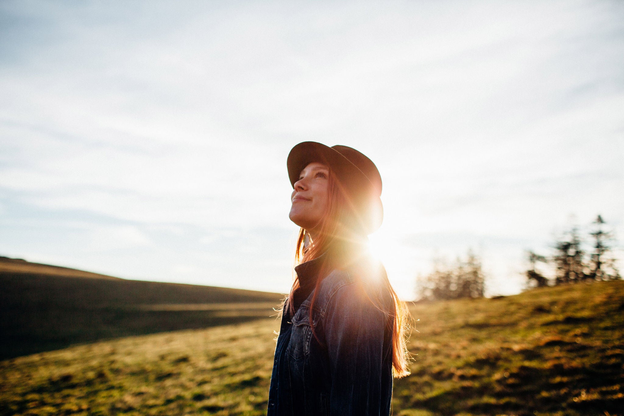 girl with hat looking upwards in the Black Forest Germany