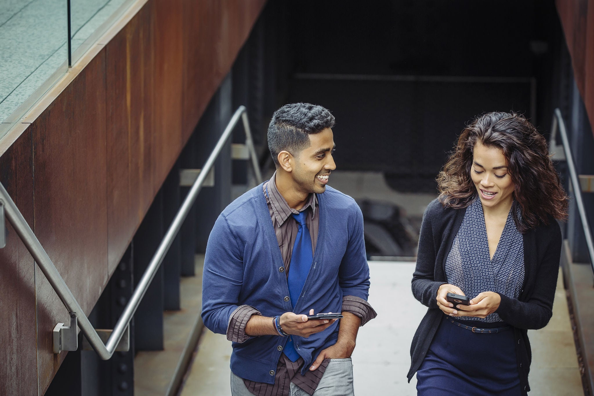 Man-and-woman-talking-while-walking-up-the-stairs.