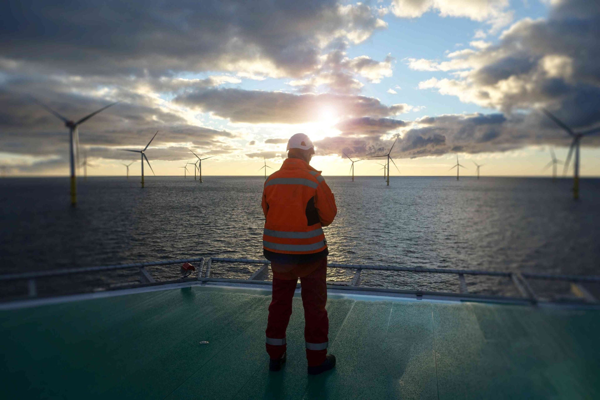 person-looking-at-wind-turbines-in-the-distance