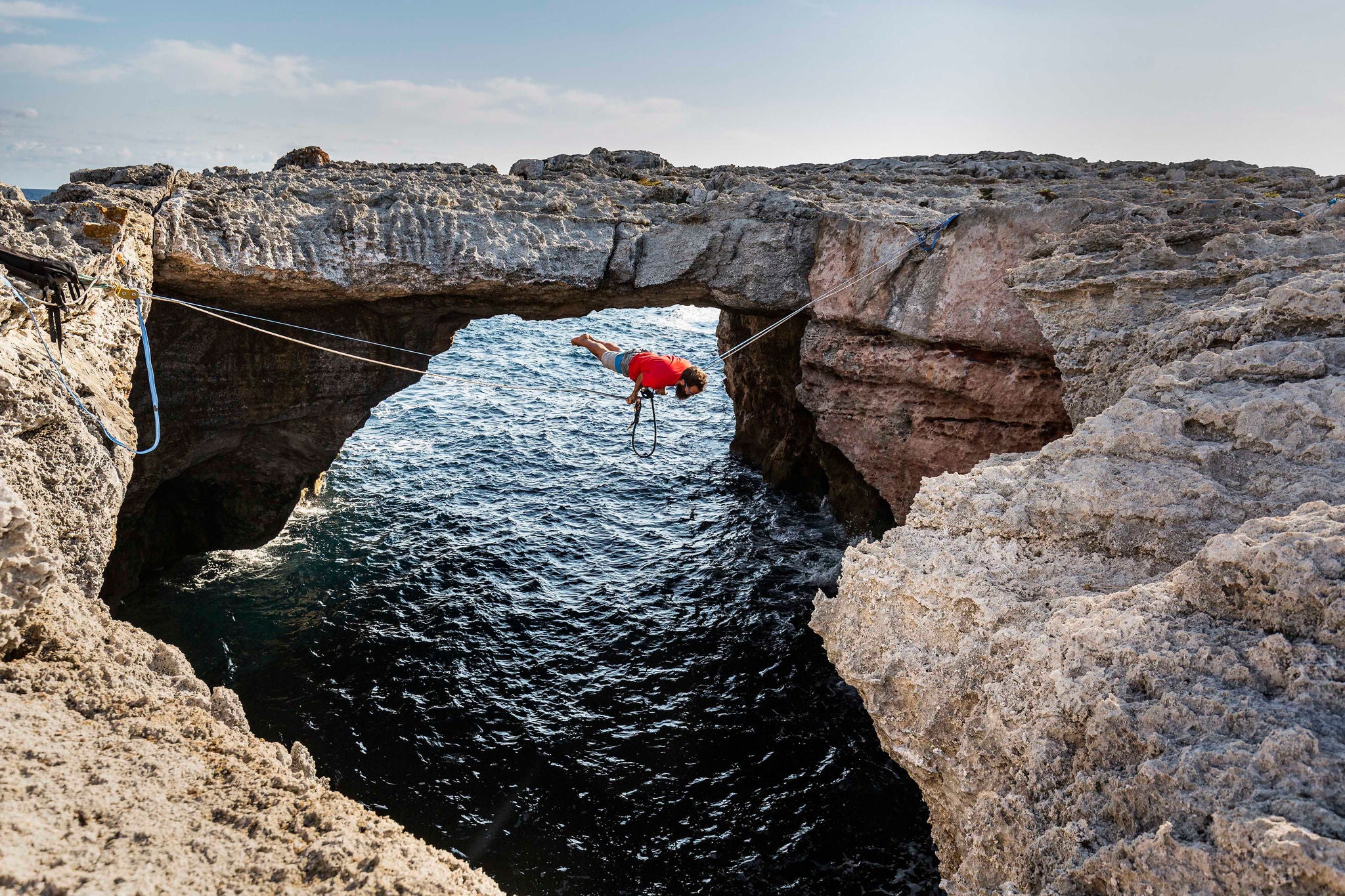 EY Man practicing slacklining at the sea in Minorca Spain