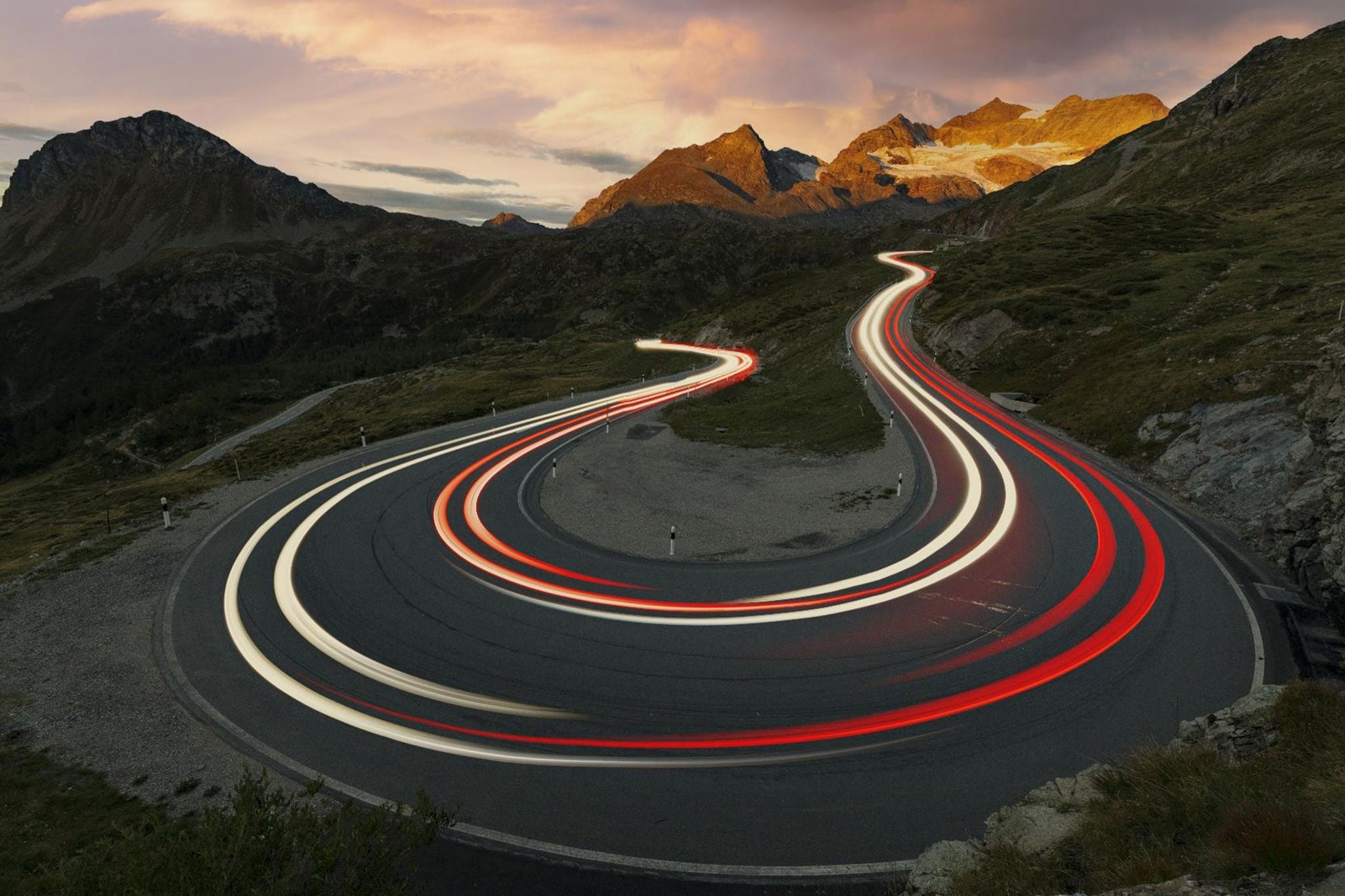 Car trails lights on mountain road Switzerland