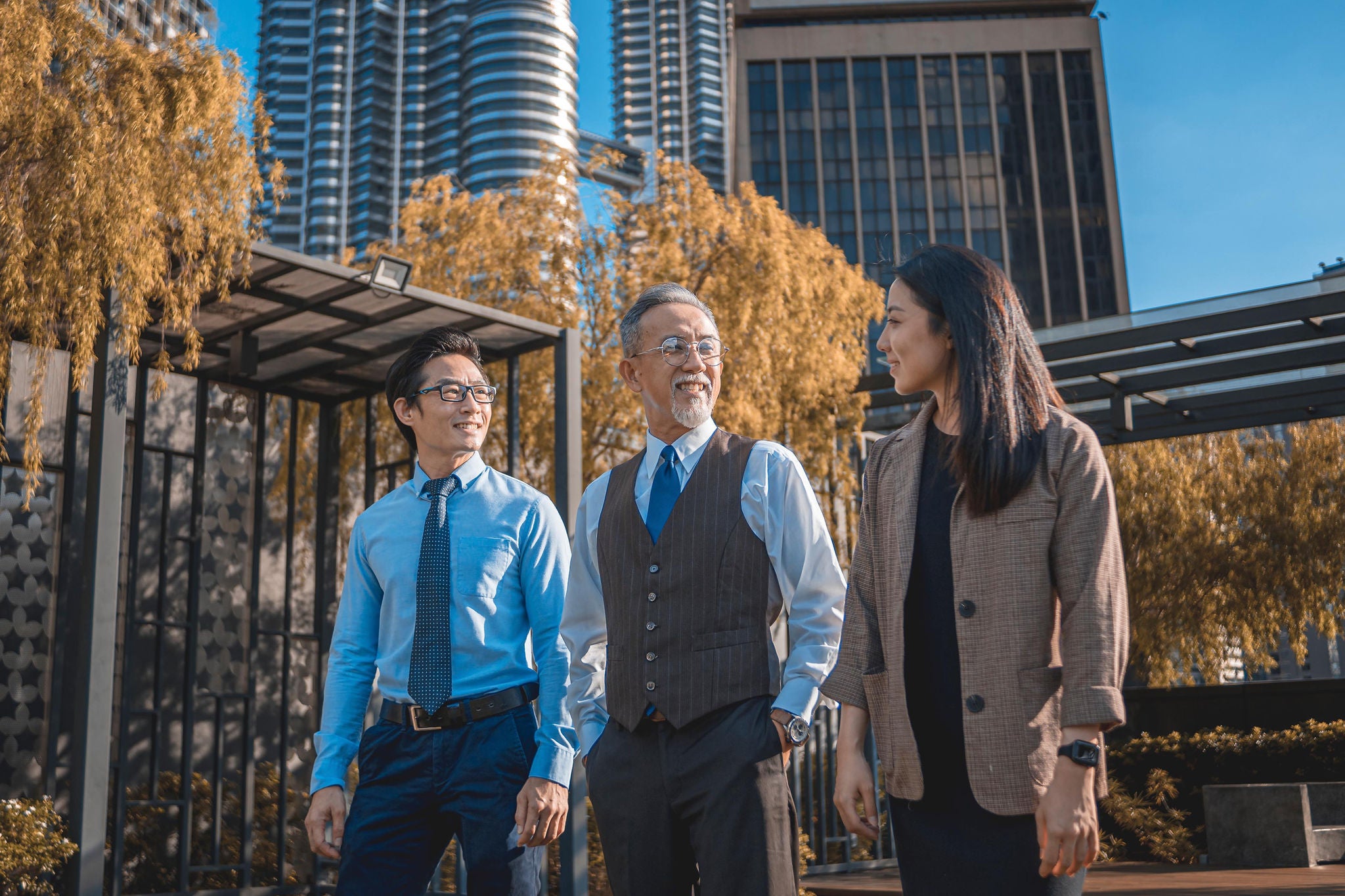 Asian Chinese CEO talking to his management team at rooftop garden of his office in the morning