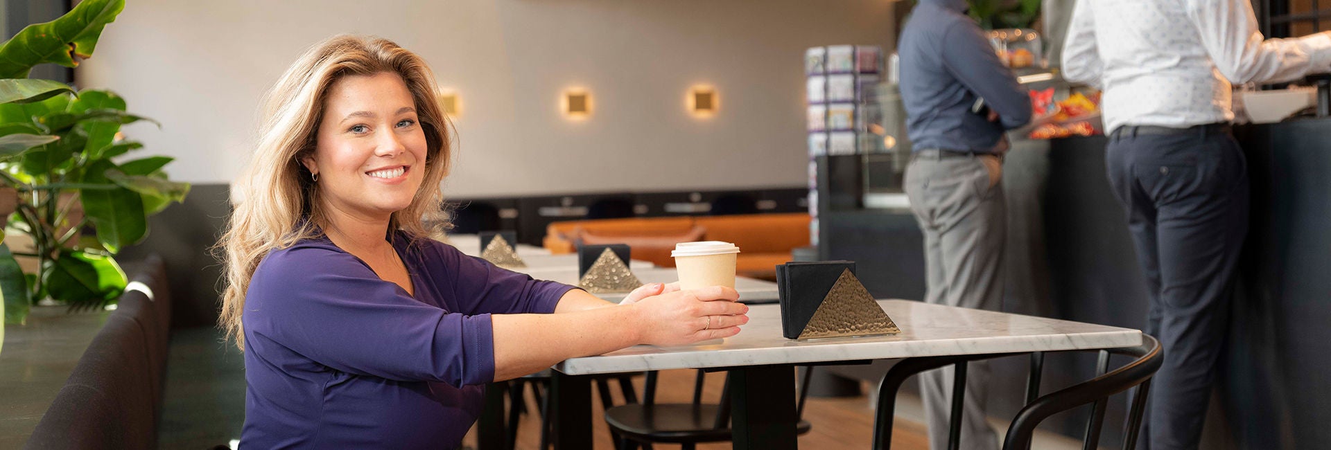 A lady is sitting in cafe shop