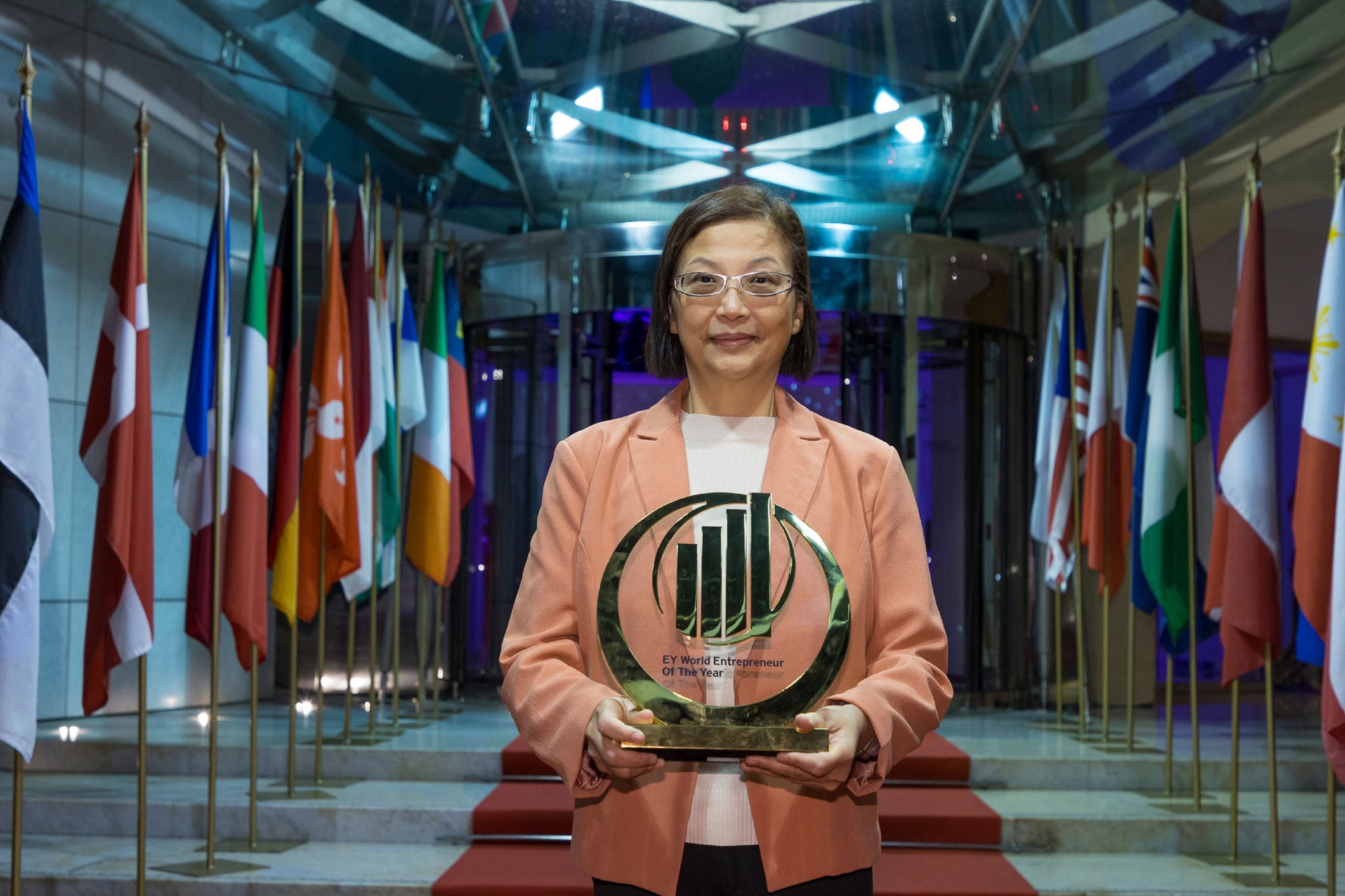 Woman holding Entrepreneur of the year award