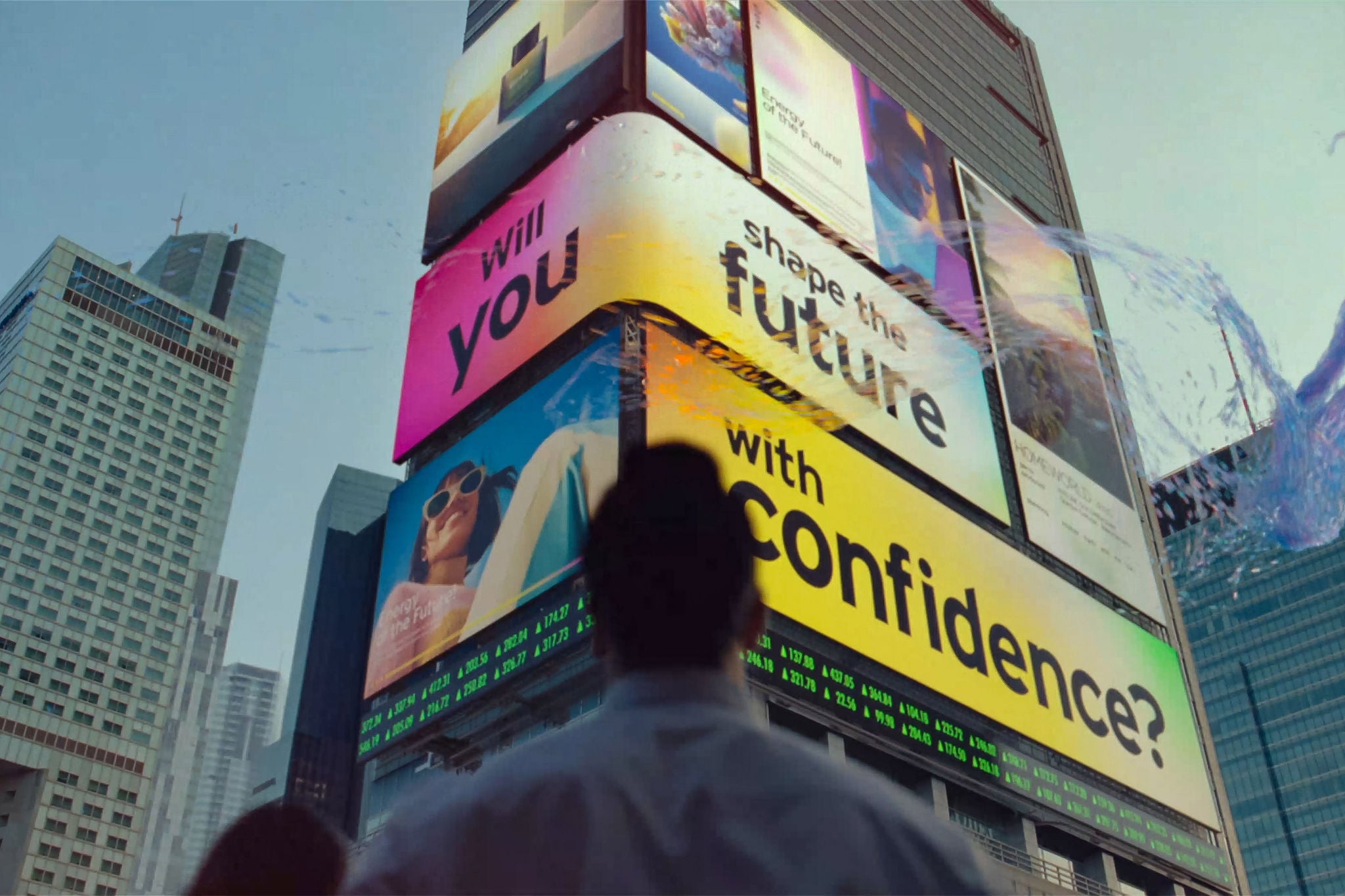 A man looking at EY transformation billboard