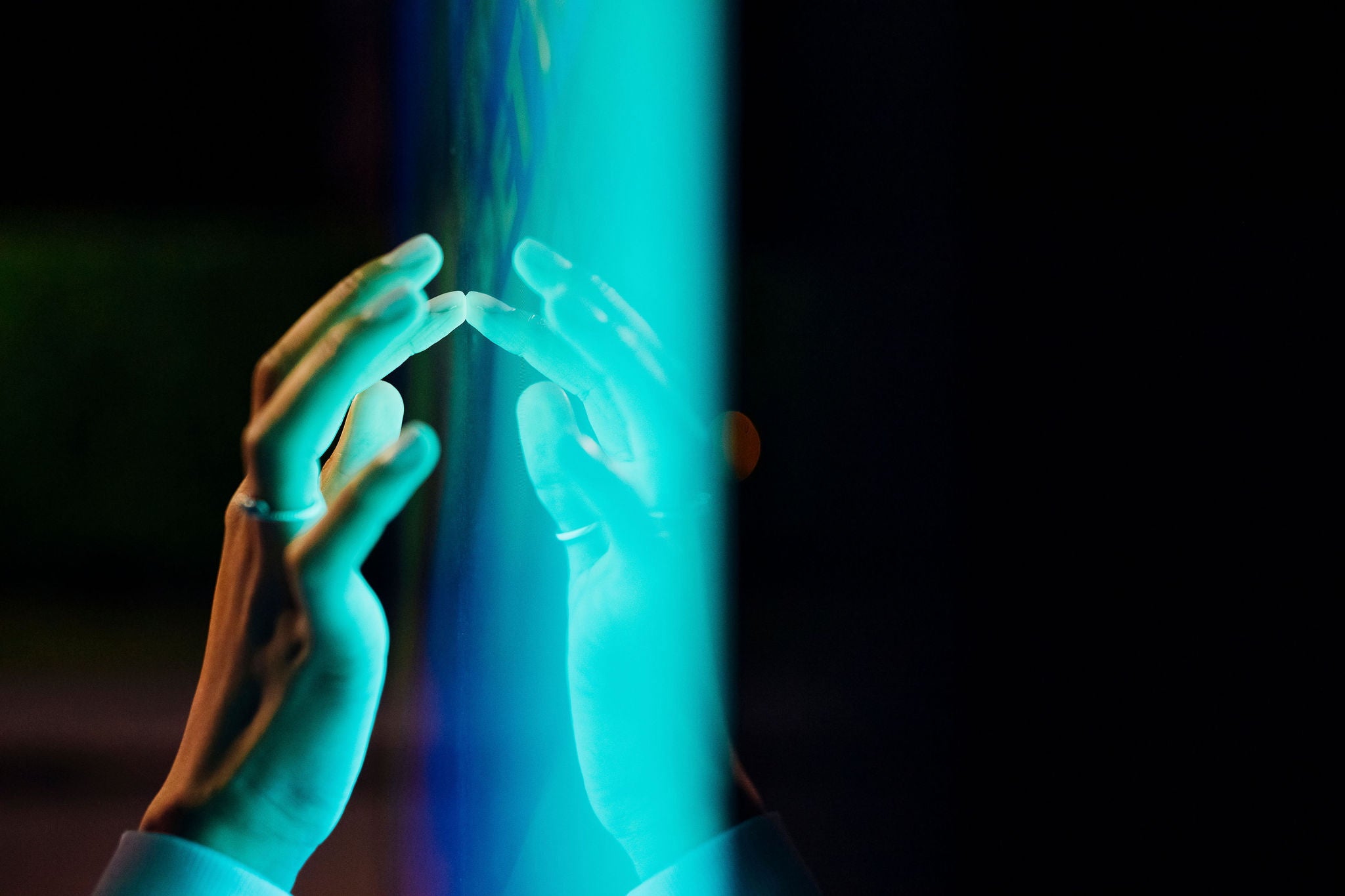 Woman touching kiosk screen at night