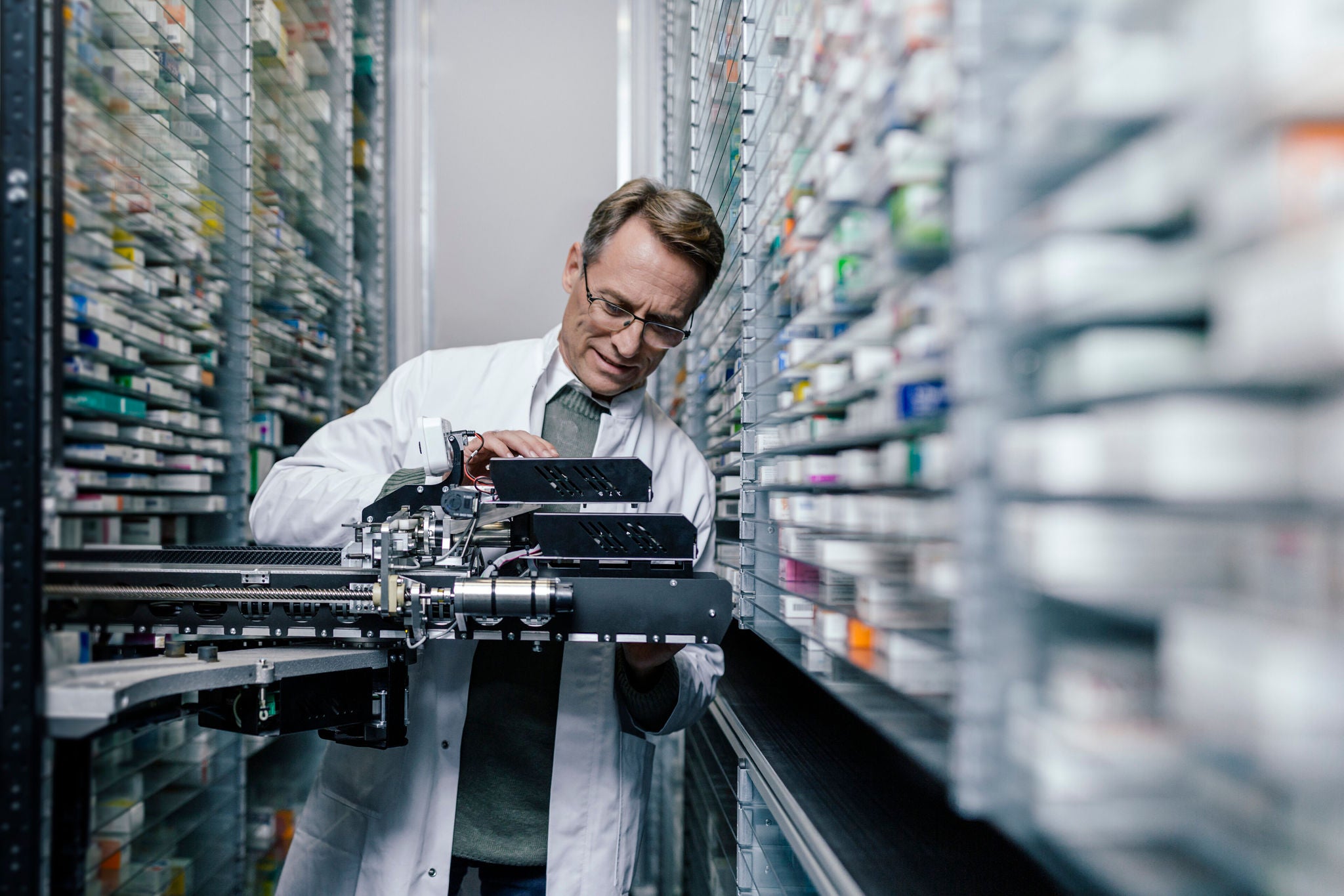 A pharmacist works in a warehouse with medicines