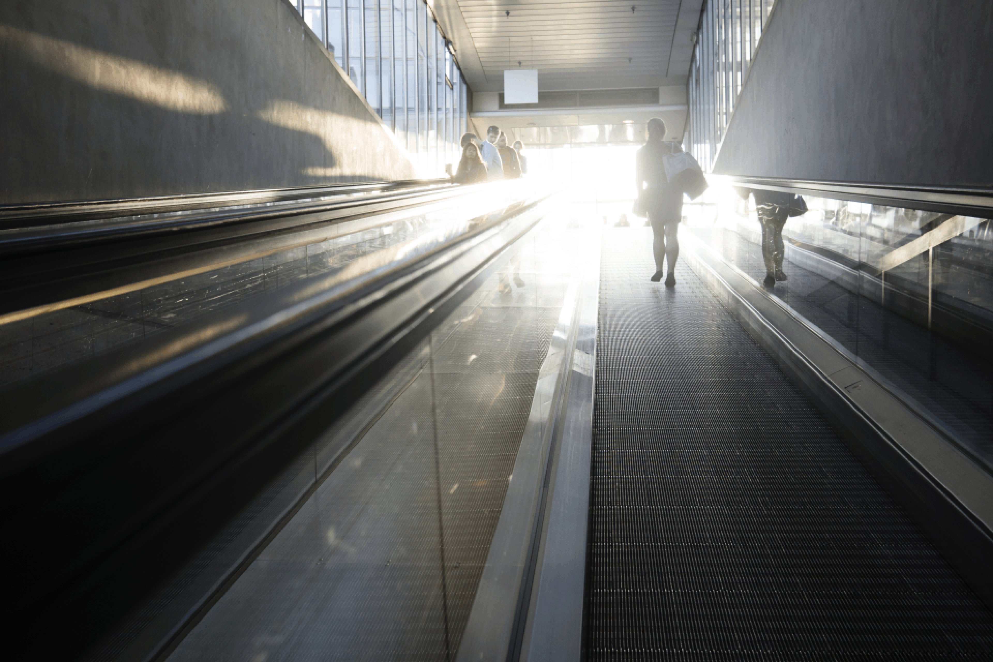 Man worker abroad climbing escalator