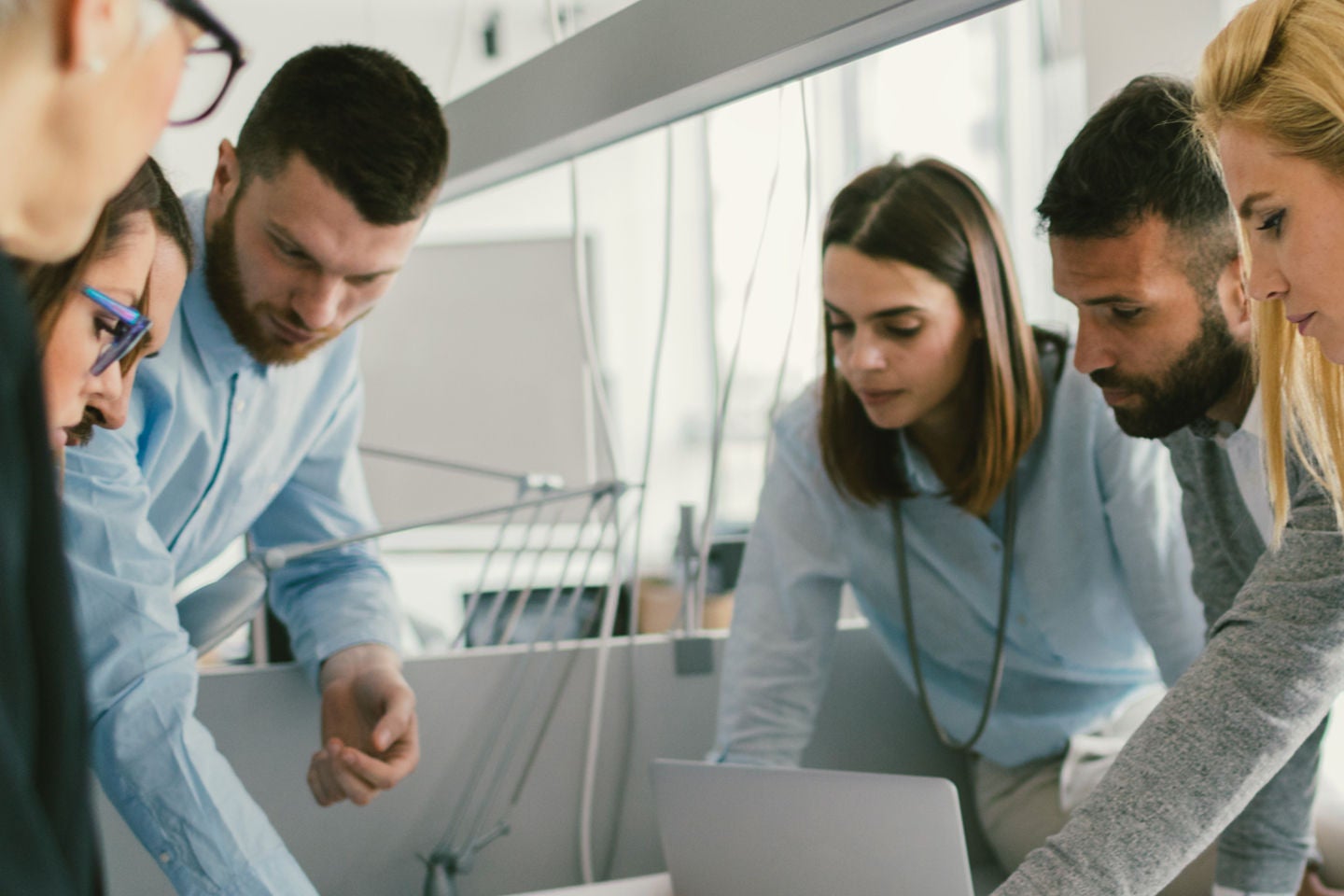 a group of employees discussing pe lab