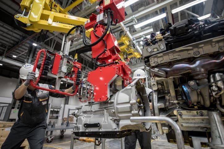 worker checking the machines in a factory