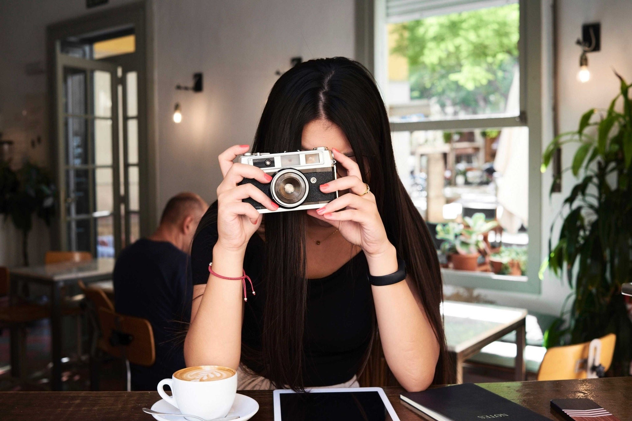 ey-woman-taking-picture-camera-coffee-shop