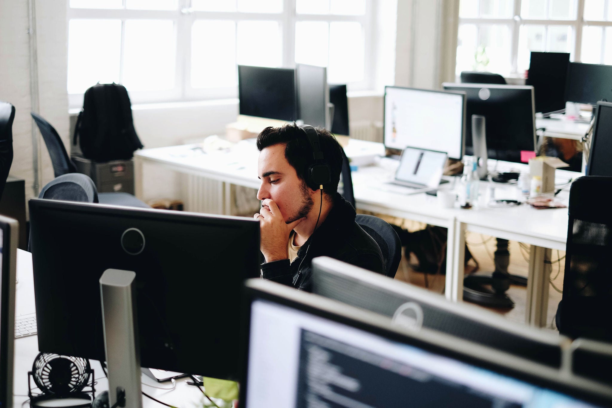 Man with headphones working in an office