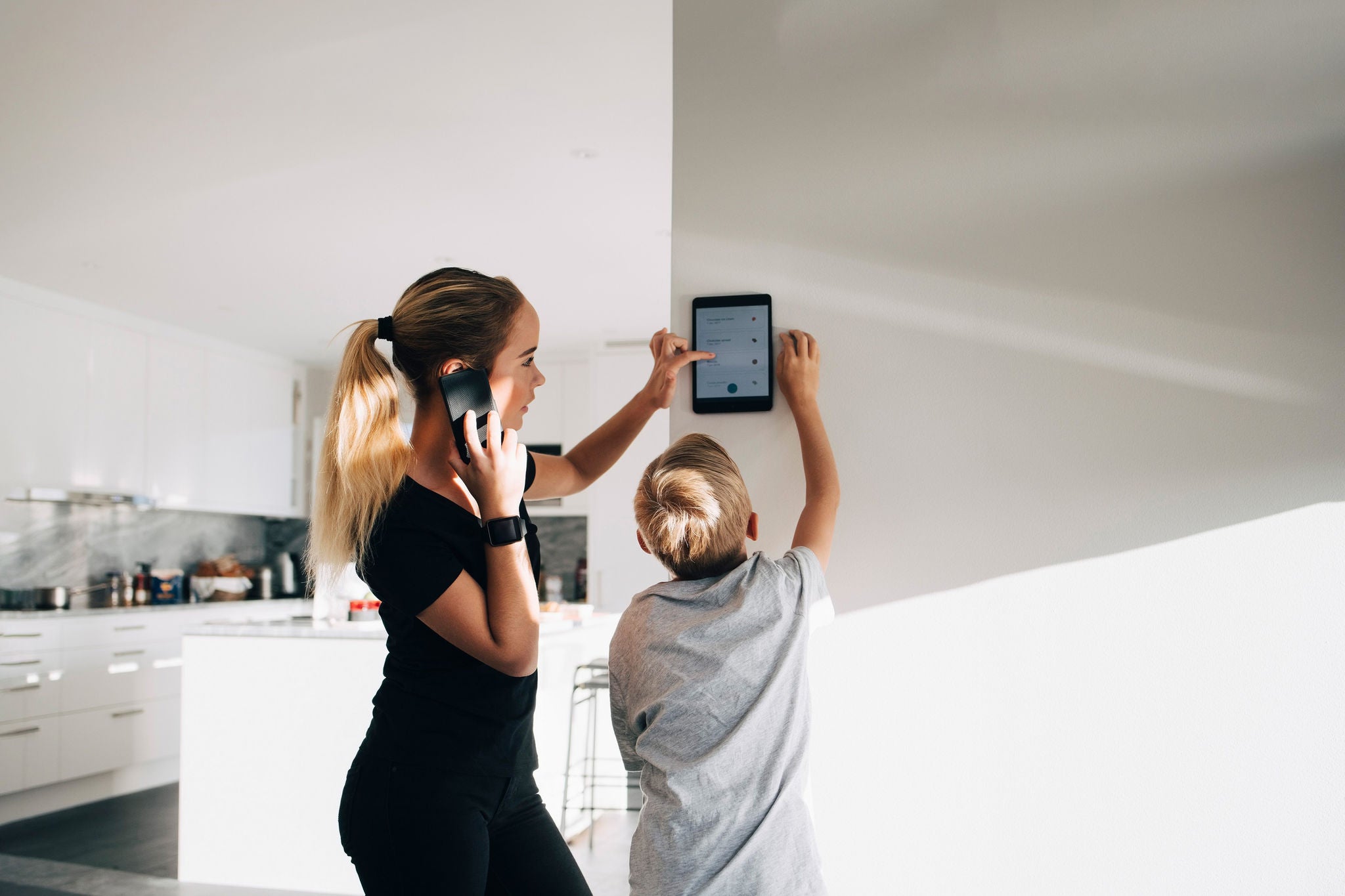 Girl talking on phone using digital tablet