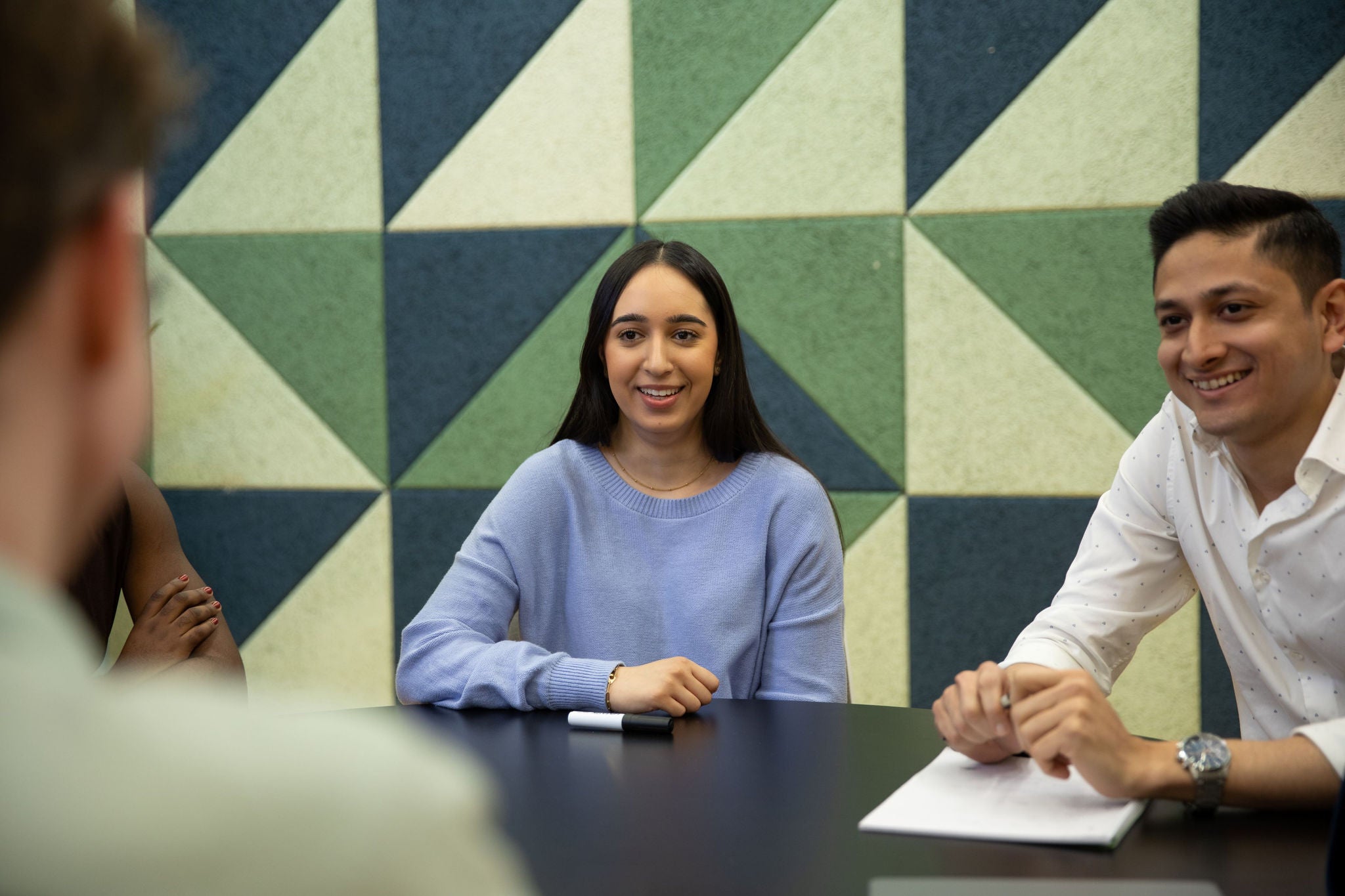 EY Students talking around a table