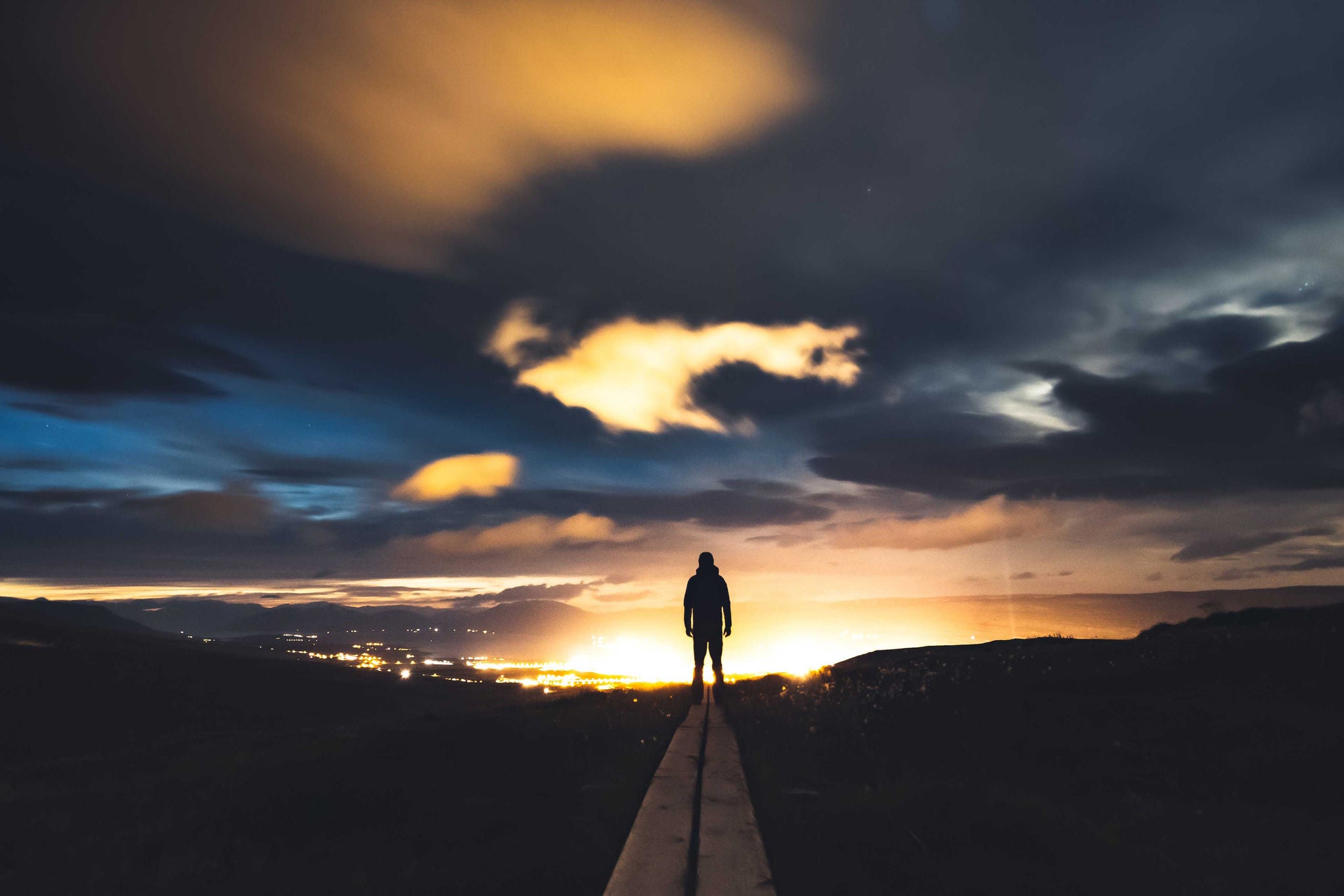 Silhouette of a man with sun setting in the background