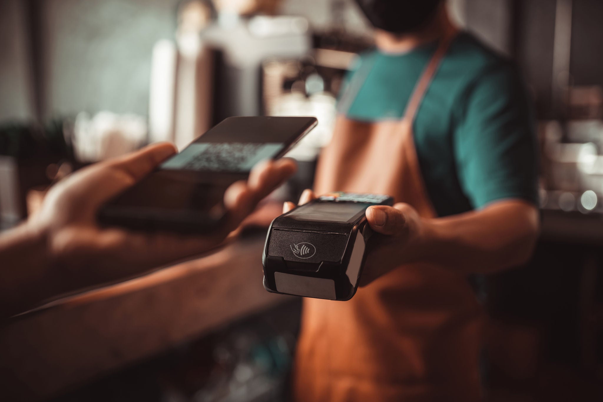 Smartphone QR code payment with credit card reader machine at the cafe